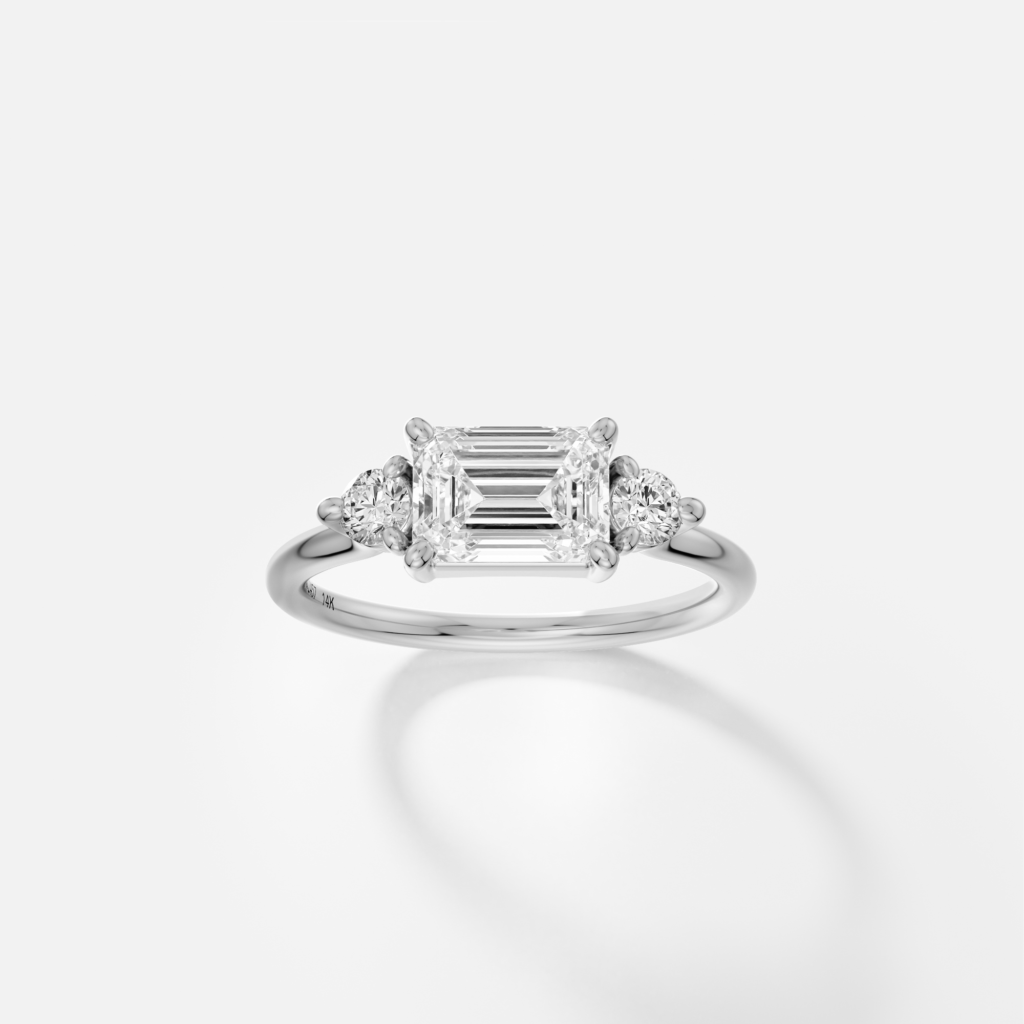 Emerald cut solitaire east west orientation with round accent stones three stone style 14k 18k gold platinum SHW Jewelry NYC