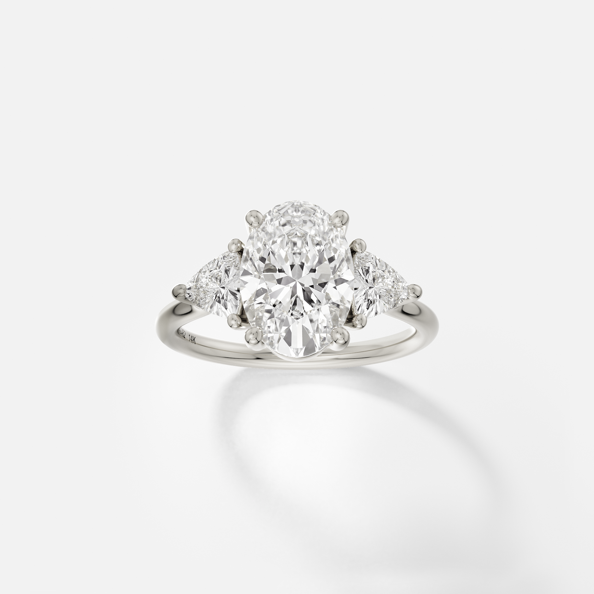Oval cut solitaire with trillion accent stones three stone style 14k 18k gold platinum SHW Jewelry NYC