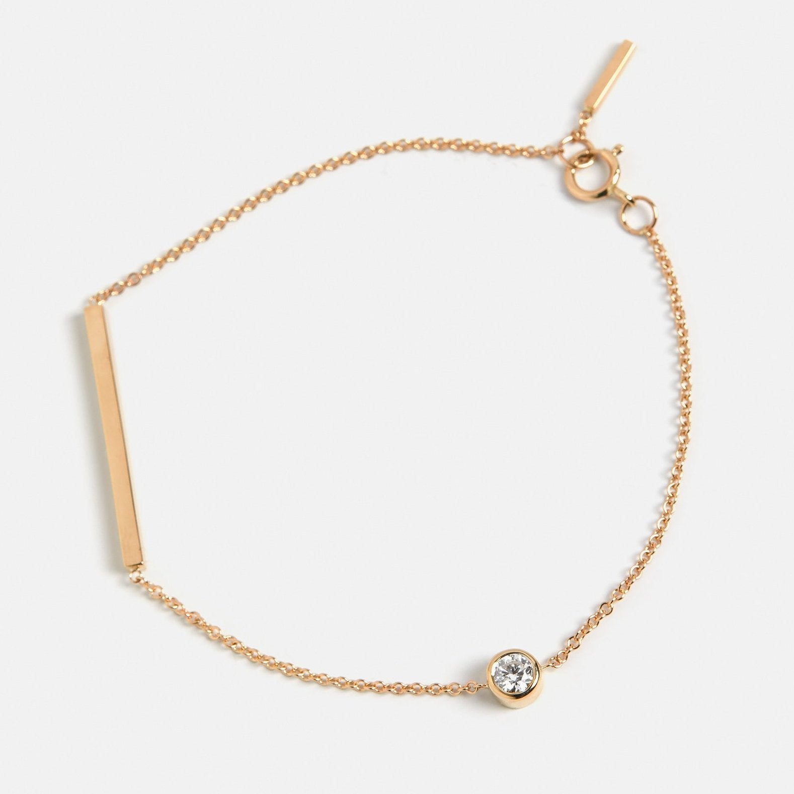 Cool bracelet with delicate chain and asymmetrical lab created white diamond in 14 karat gold by SHW best fine jewelry store in NYC