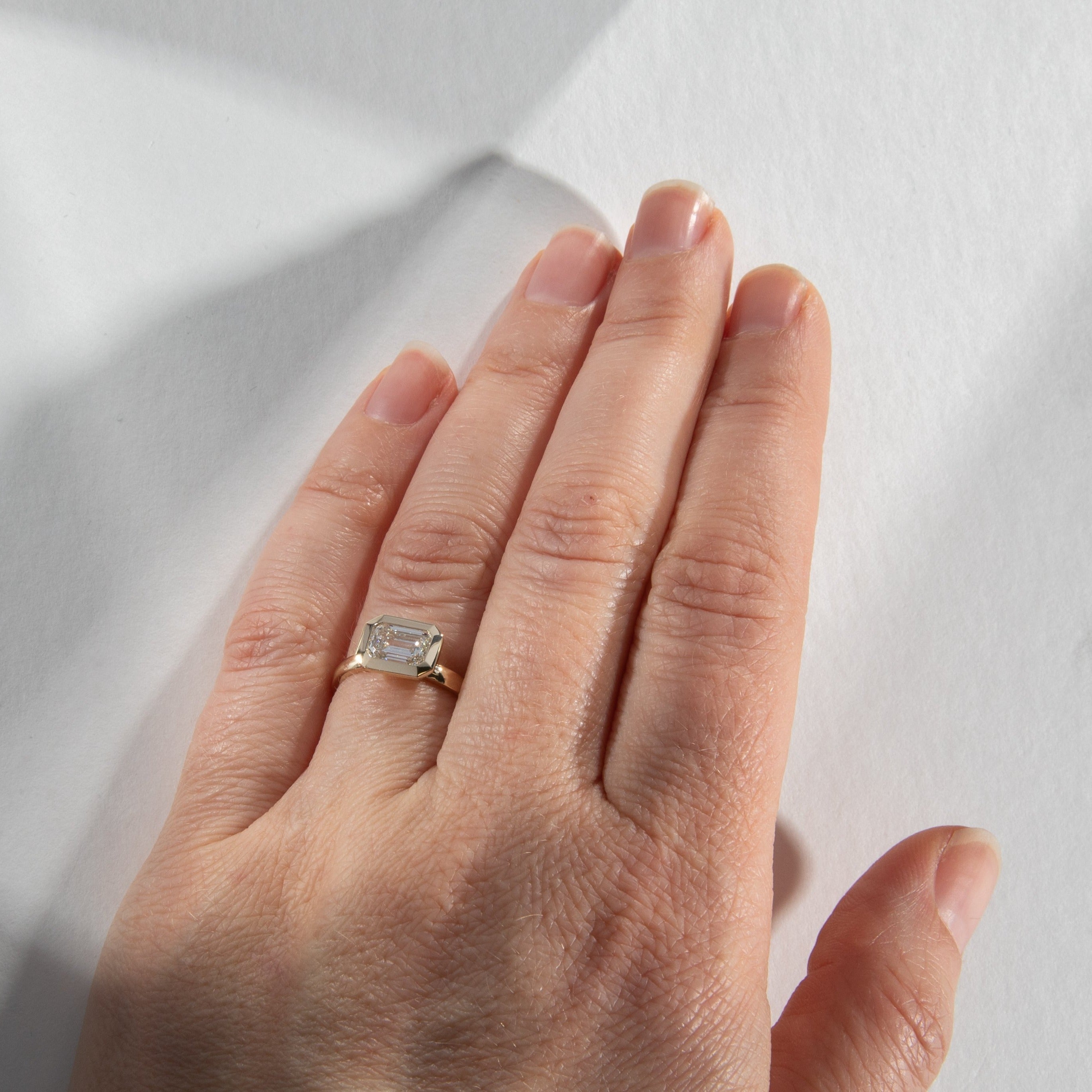 Cool Bezel Engagement Ring with 1 ct certified emerald cut lab made diamond  in 14k yellow gold by SHW famous fine jewelry stores NYC
