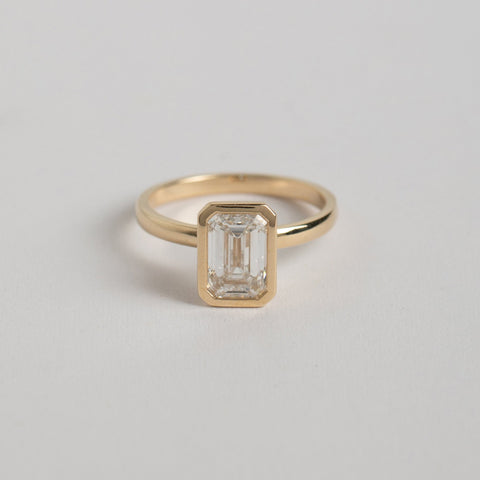 Unique Bezel Engagement Ring 1.5ct emerald-cut lab grown diamond in 14k yellow gold by SHW best fine jewelry stores in downtown NYC nearby