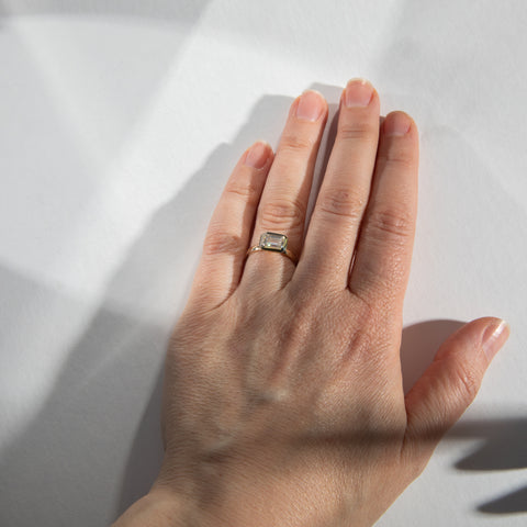 Minimal Bezel Setting Engagement Ring with 1ct lab grown east west emerald cut diamond in 14 karat yellow gold SHW fine jewelry stores NYC