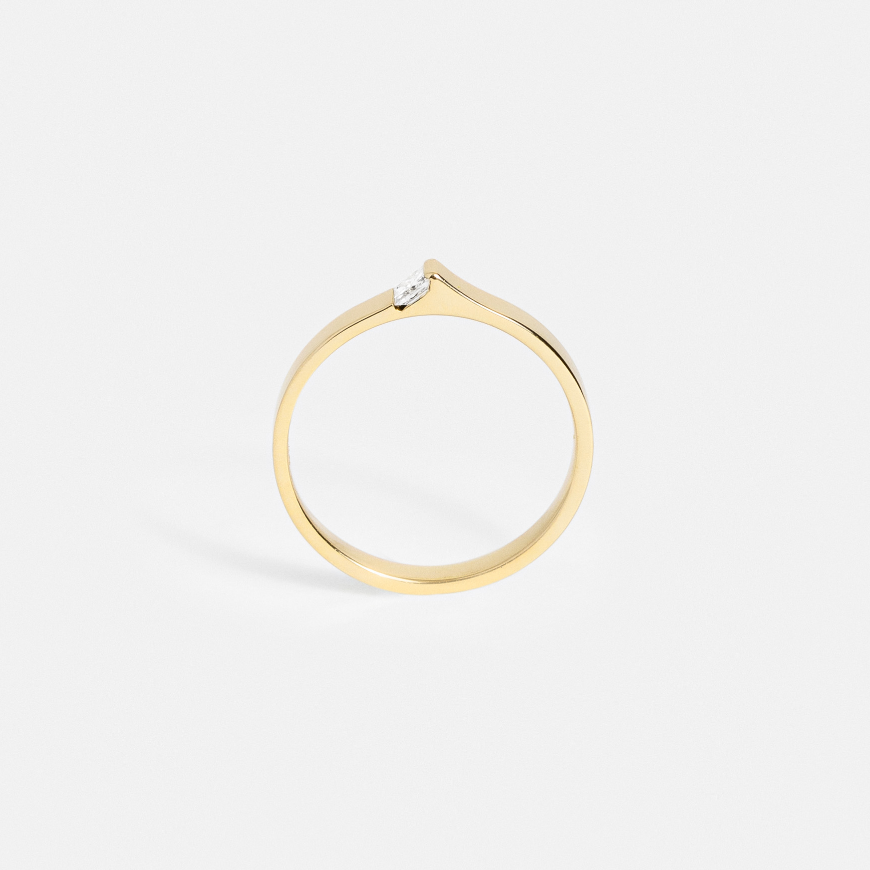 Architectural gold ring with princess-cut diamond viewed at an angle