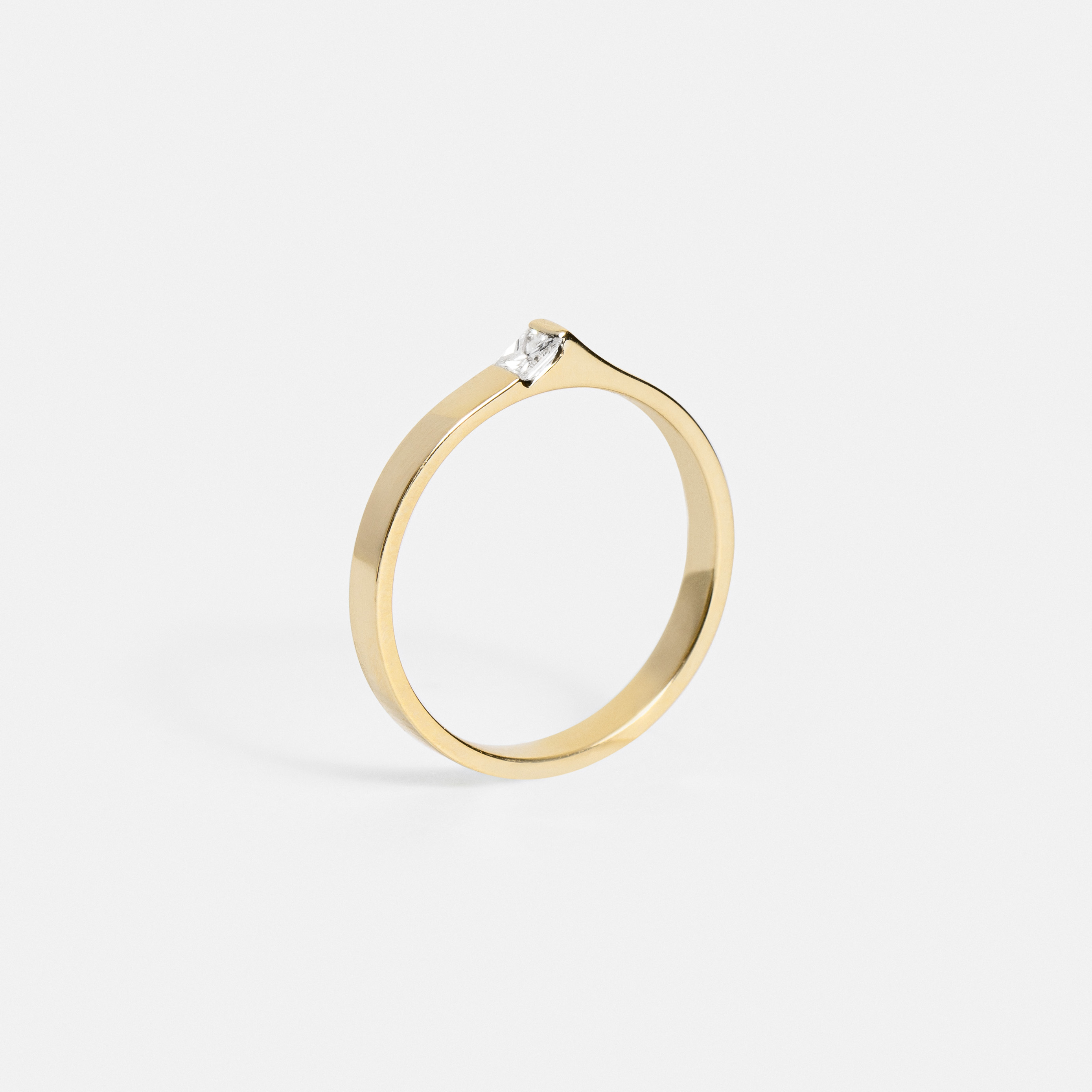 Slim gold band showing raised peak with princess diamond from the side