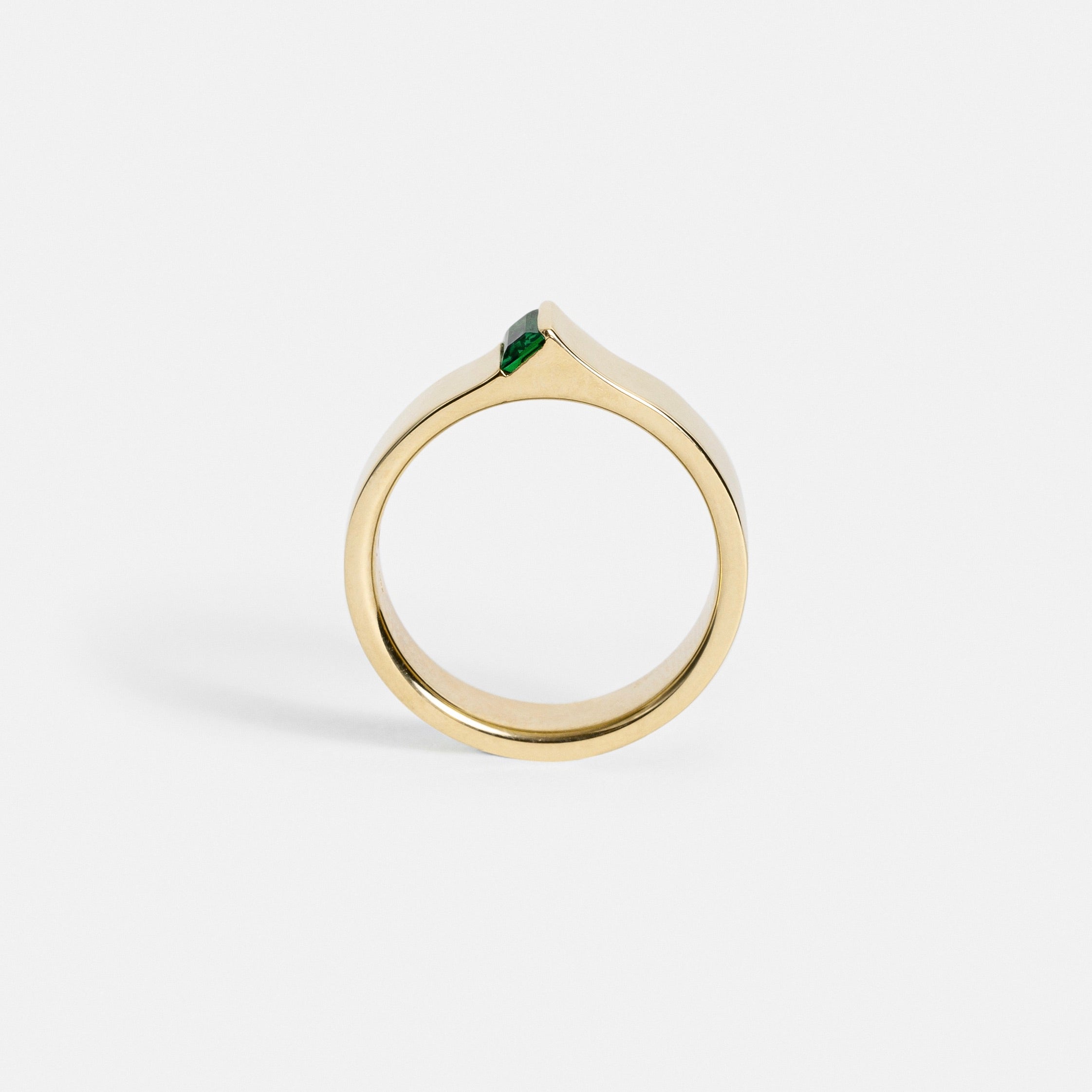 Wide gold band showing exposed baguette tsavorite from the side