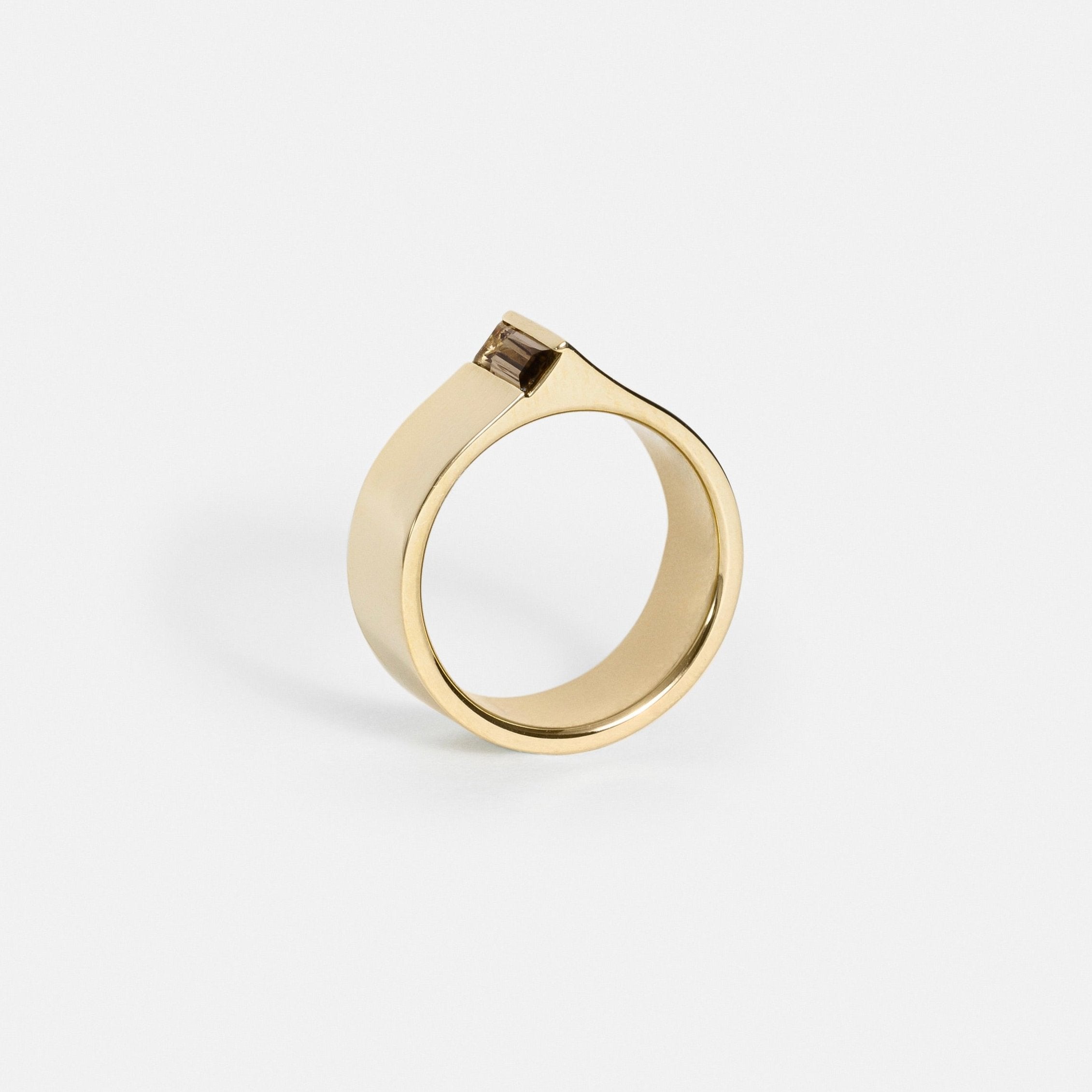 Thick flat gold ring with edge-set earthy toned baguette gemstone