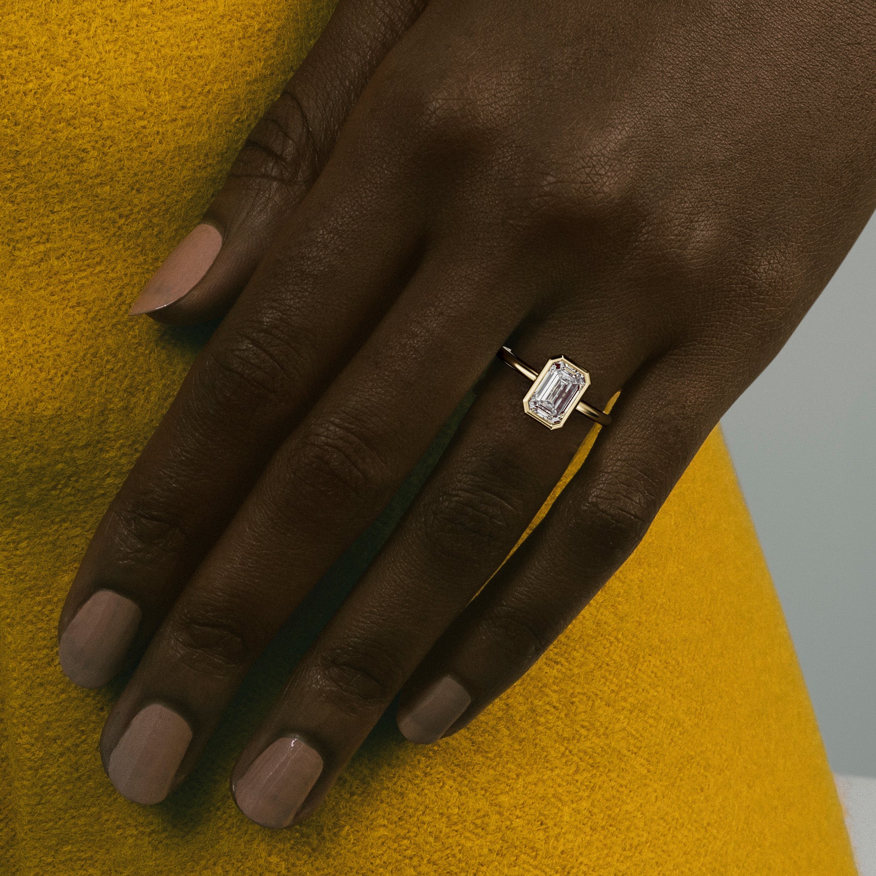 Close view of round brilliant diamond in thin bezel on delicate round band