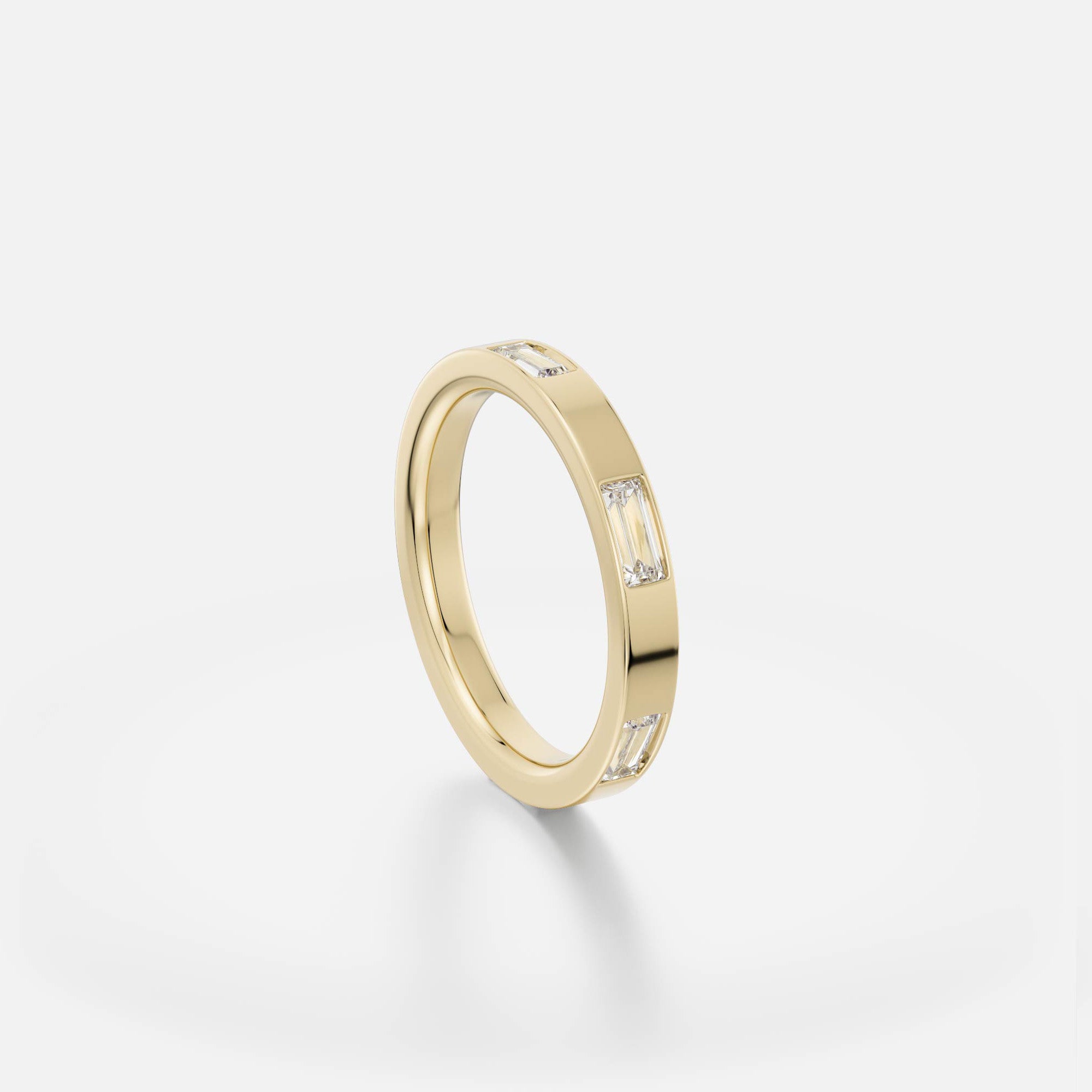 Flat gold band with continuous baguette diamonds shown at an angle
