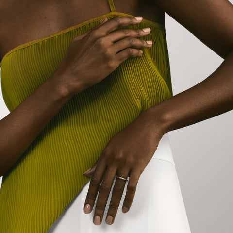 Minimal 2mm gold wedding band shown worn in natural light