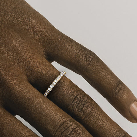 Stackable pavé diamond wedding band shown worn in natural light