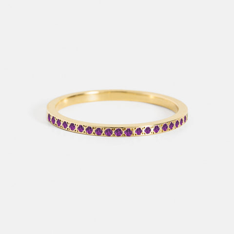 Close view of thin gold half eternity band with round amethyst pavé