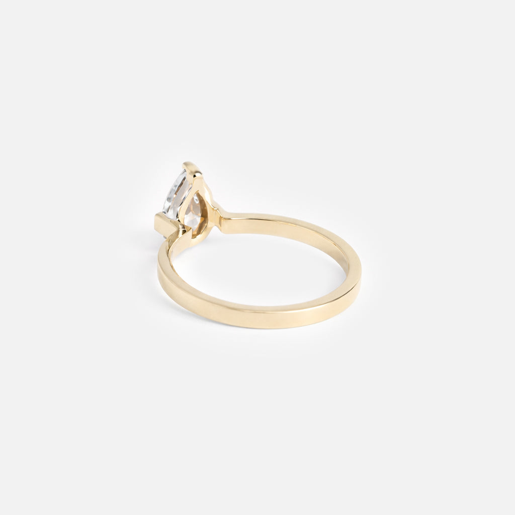 1.30 ct pear diamond engagement ring with open three-prong setting on slender flat profile band