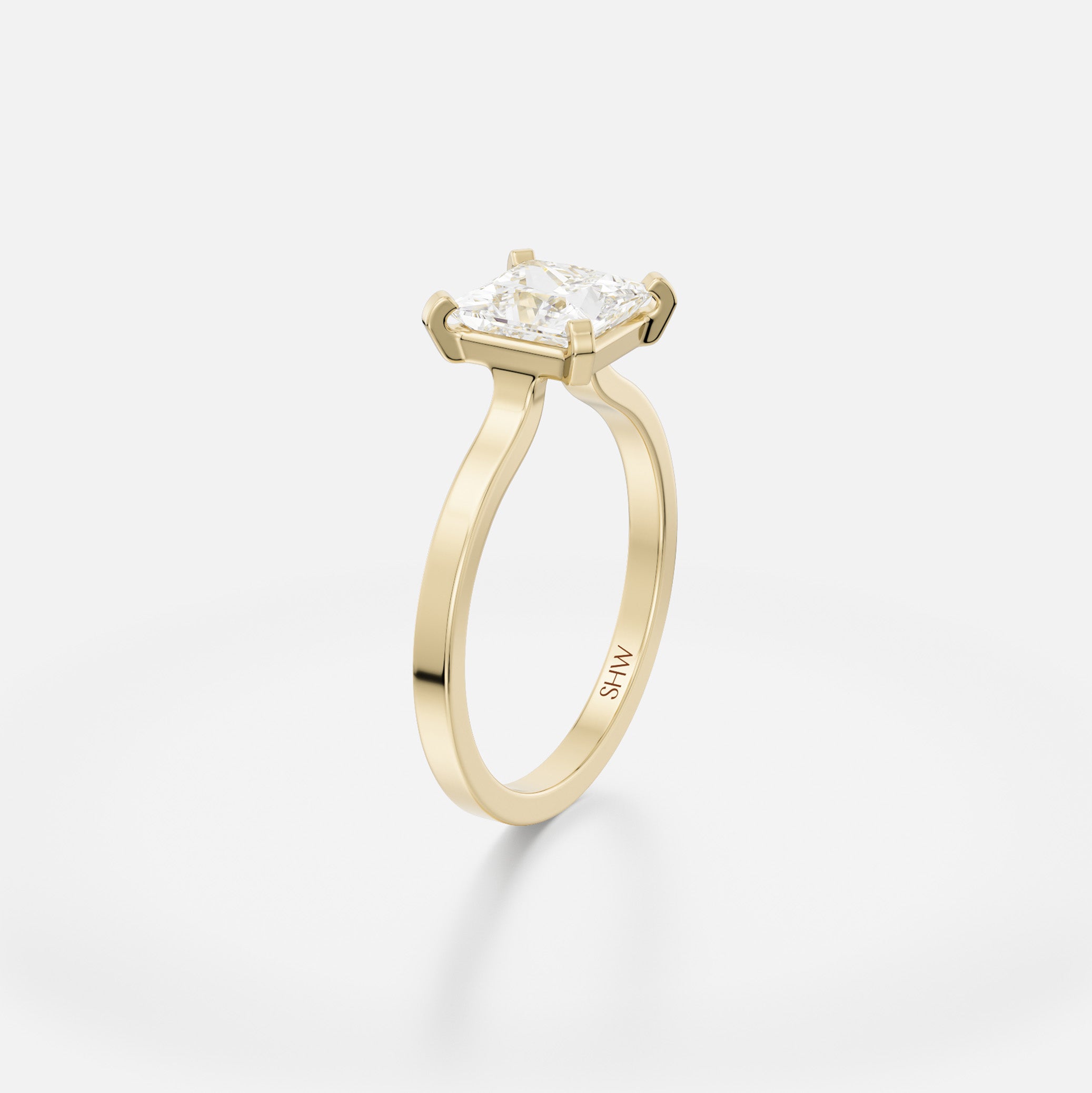 Delicate flat profile engagement ring with open setting holding 1.5 ct princess-cut diamond