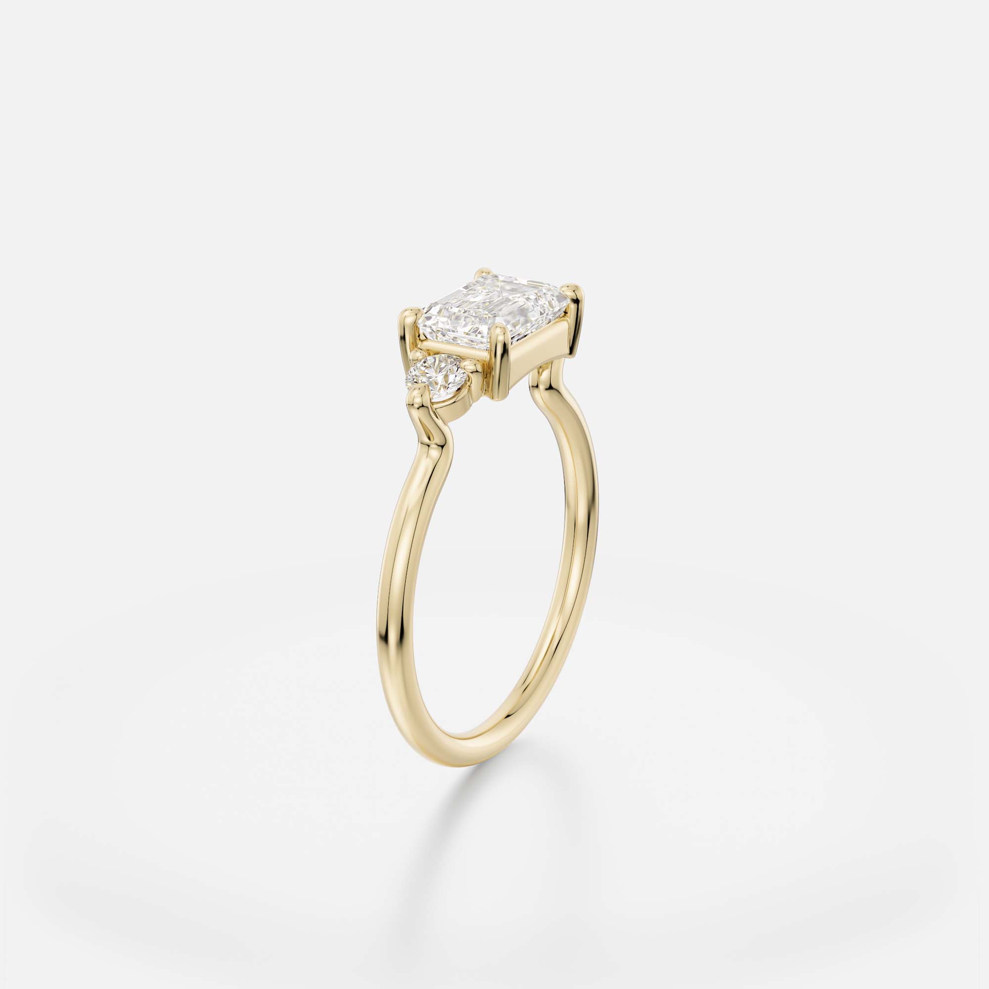 Dainty band engagement ring with east west emerald cut center and round side stones cluster design SHW Fine Jewelry NYC