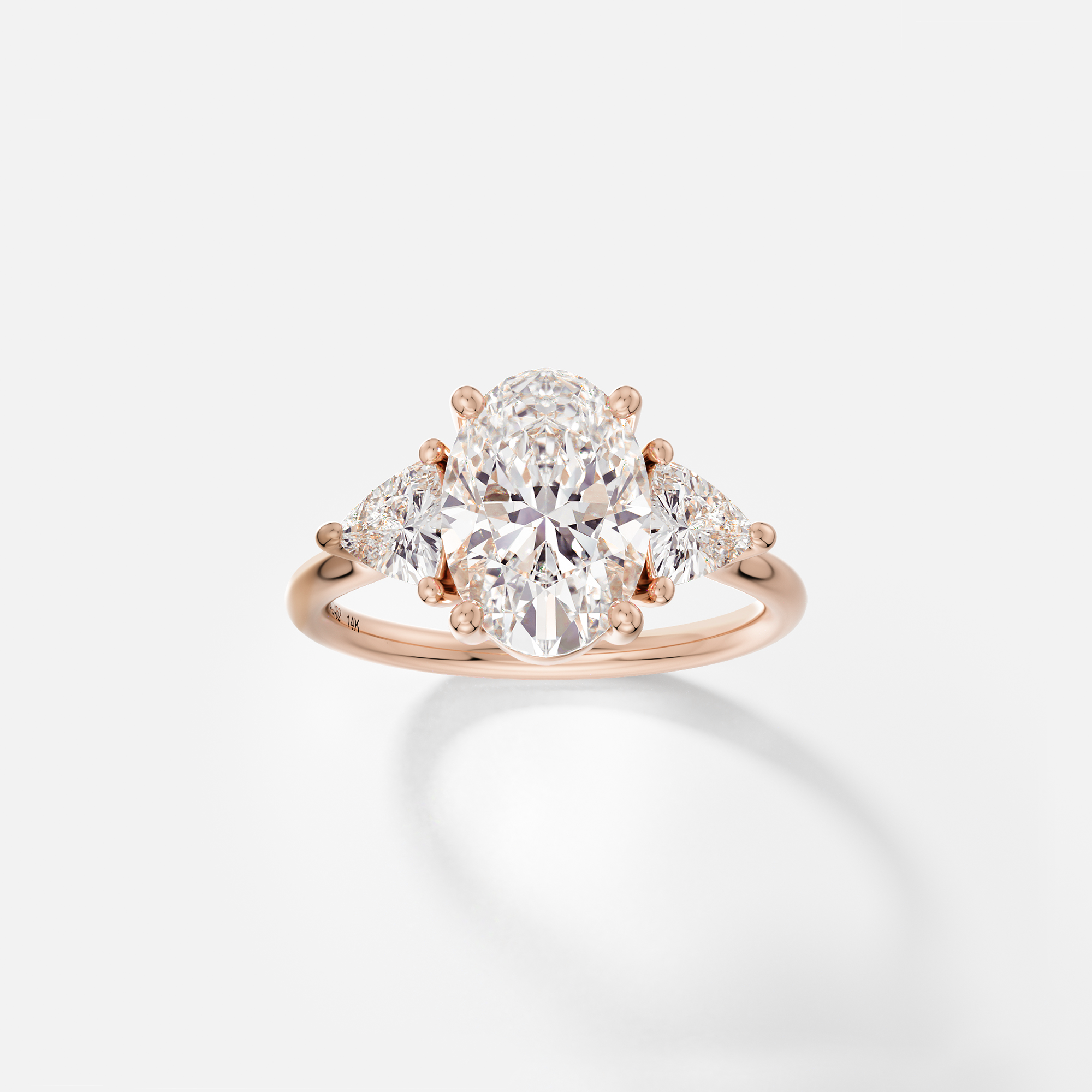 Dainty band engagement ring with oval cut center and trillion side stones cluster design SHW Fine Jewelry NYC