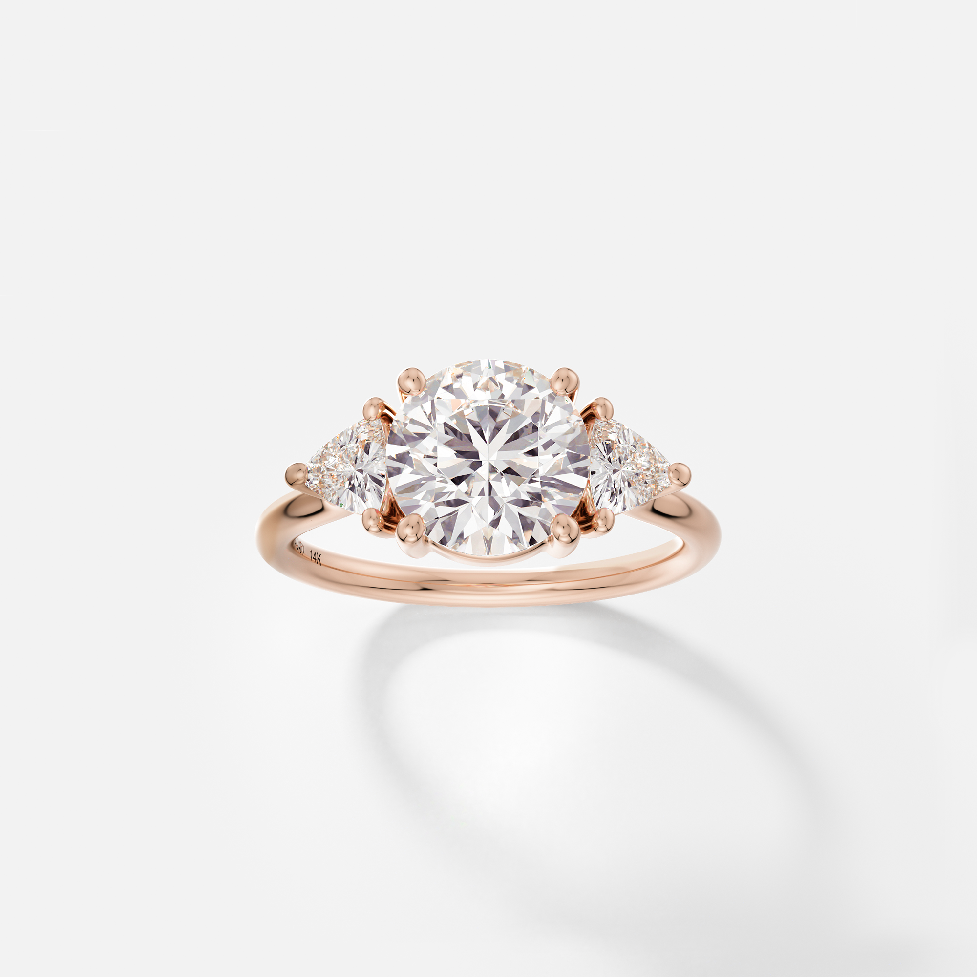 Dainty band engagement ring with round cut center and trillion side stones cluster design SHW Fine Jewelry NYC