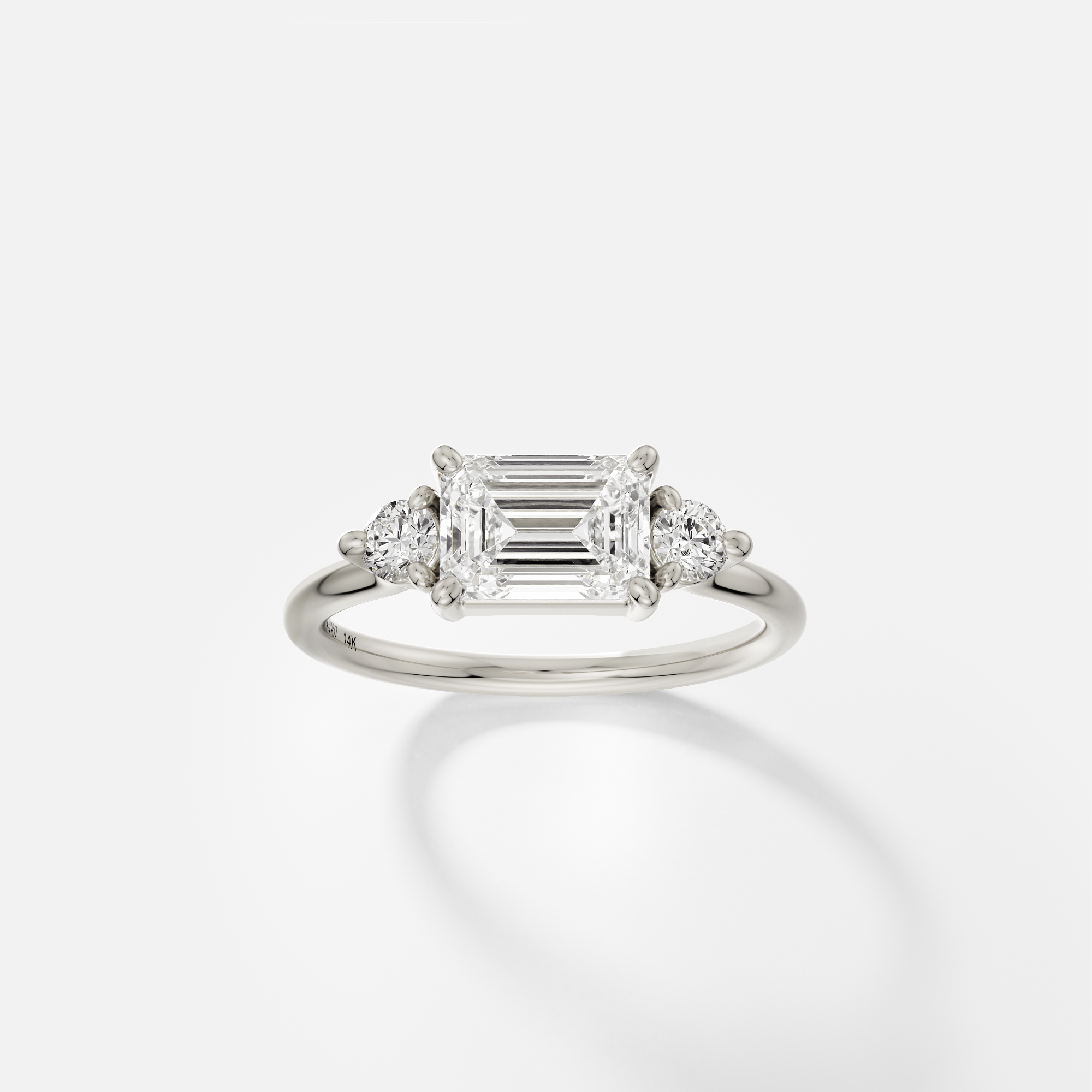 Three stone emerald cut ring with round diamond accents east west setting 14k 18k gold platinum SHW fine jewelry NY