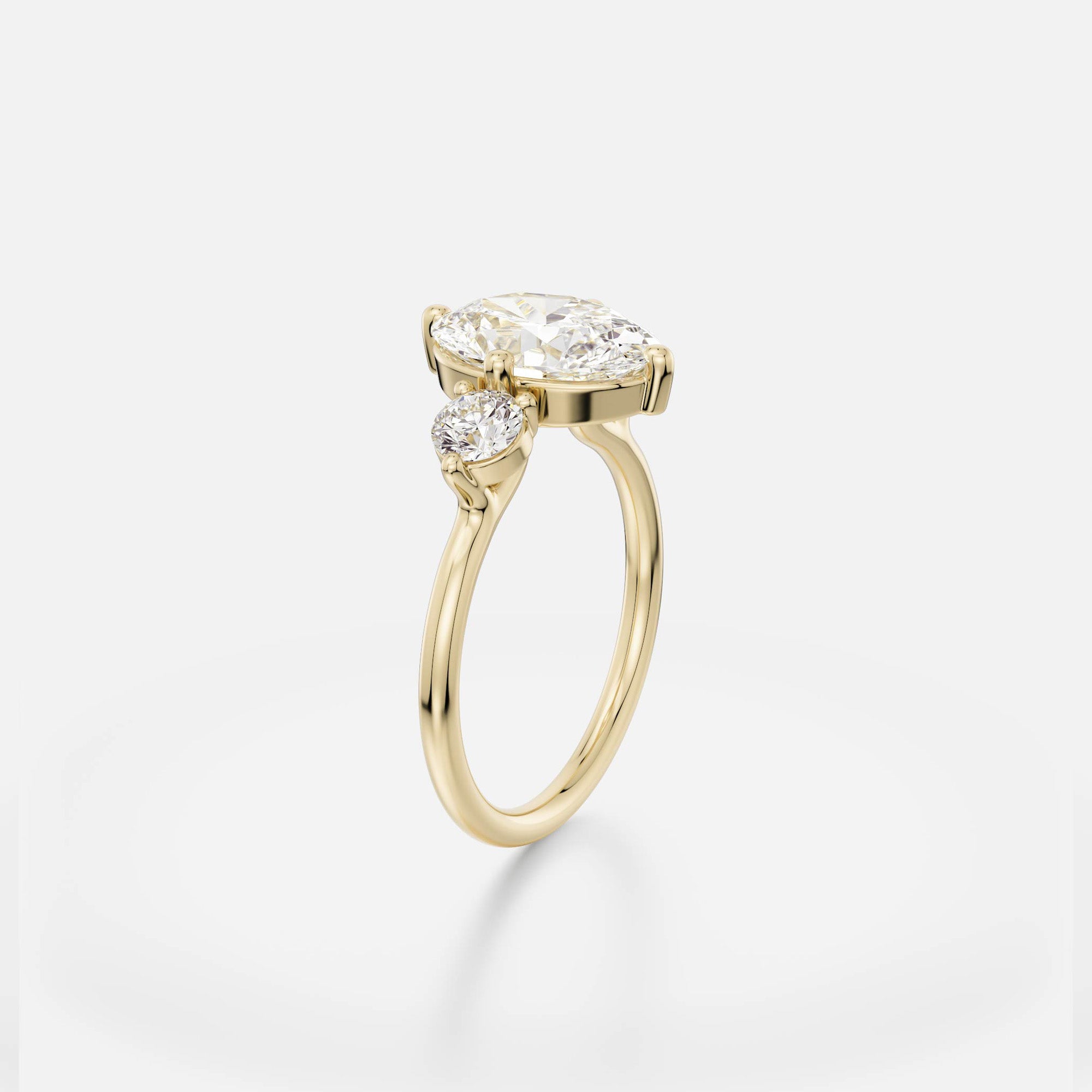 Delicate round profile band engagement ring with 2.5 ct oval diamond and round side stones in open prong setting