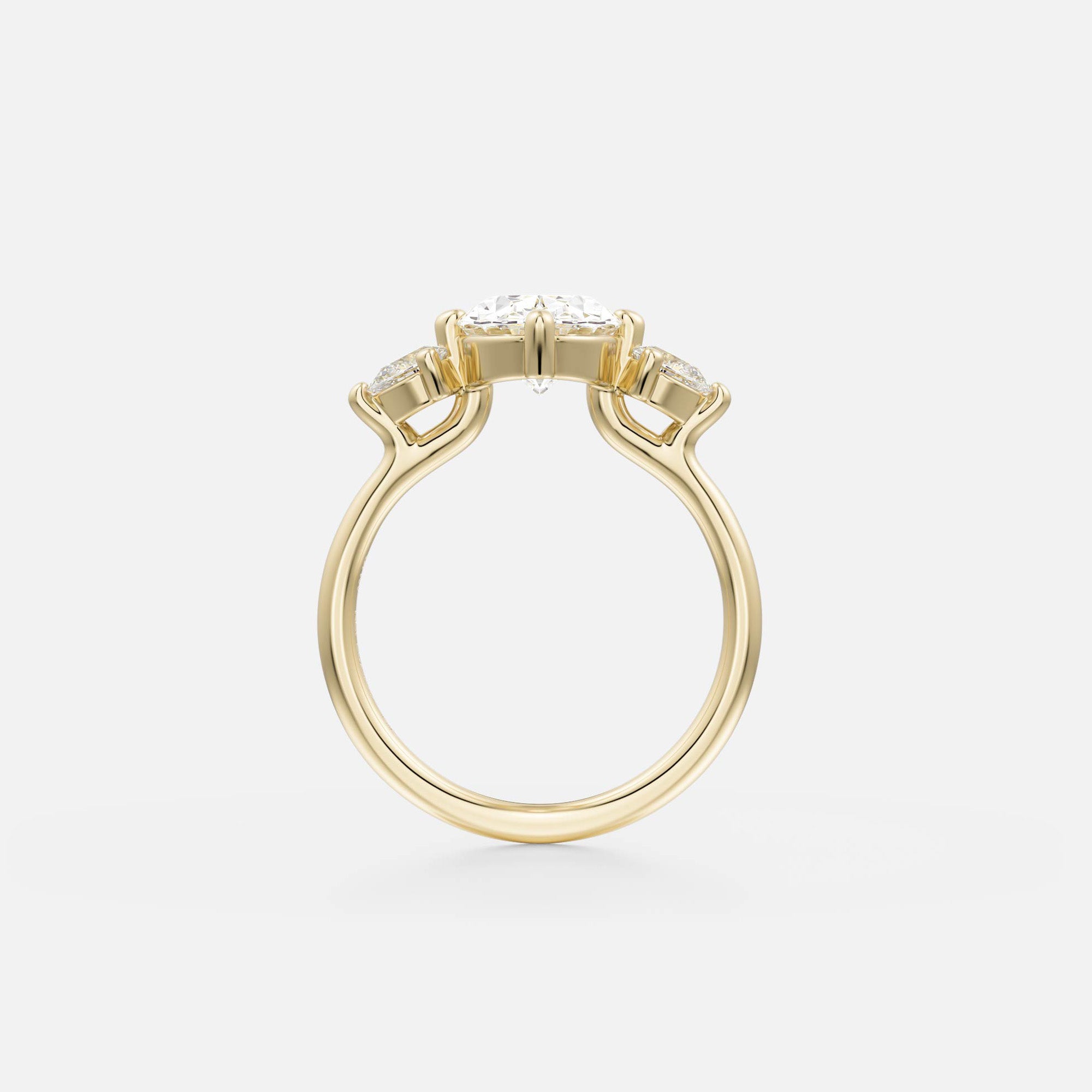 side view of oval diamond three stone engagement ring with pear side stones on delicate round profile band open setting