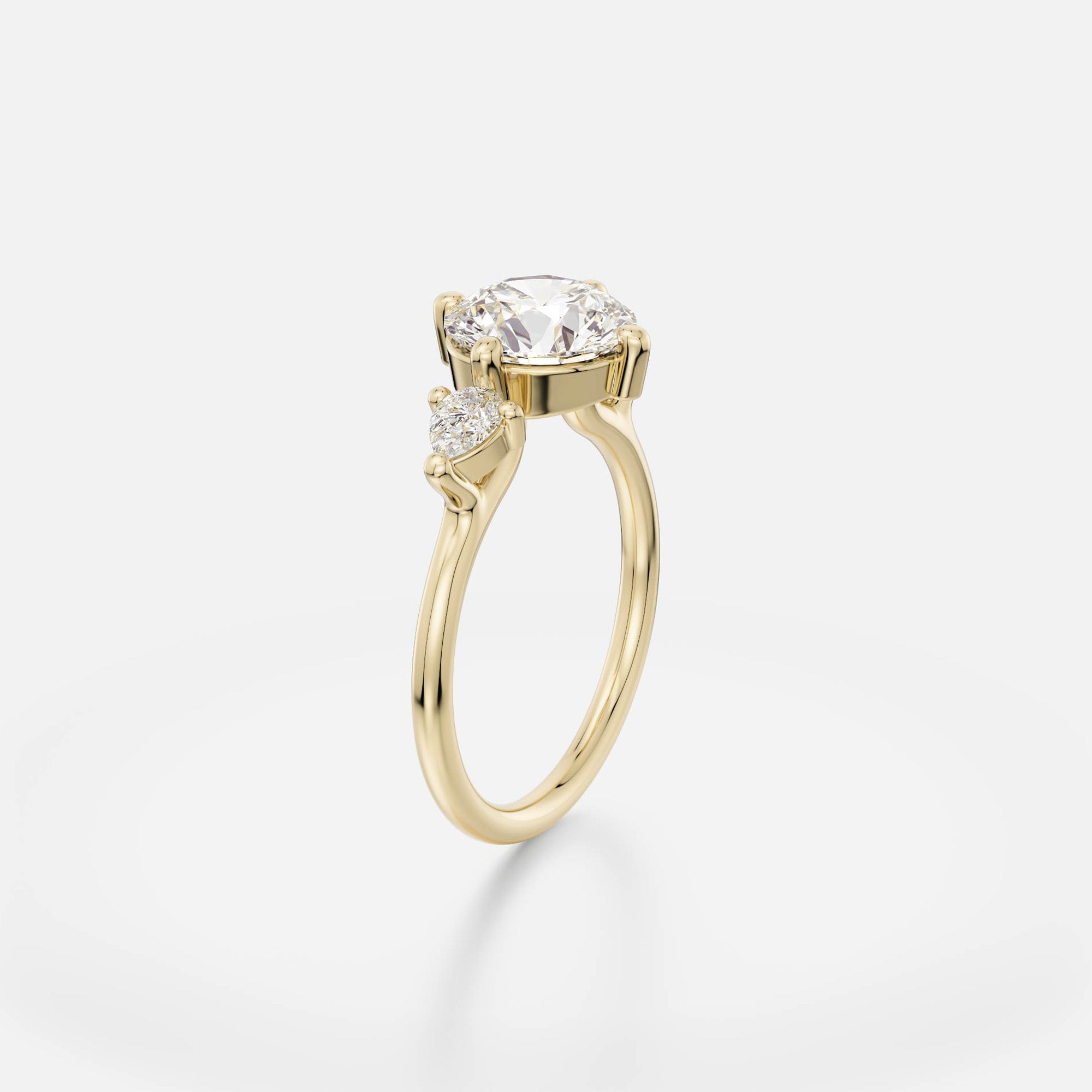 2 ct round brilliant diamond engagement ring with pear accent stones in compass prong setting on thin round band open setting