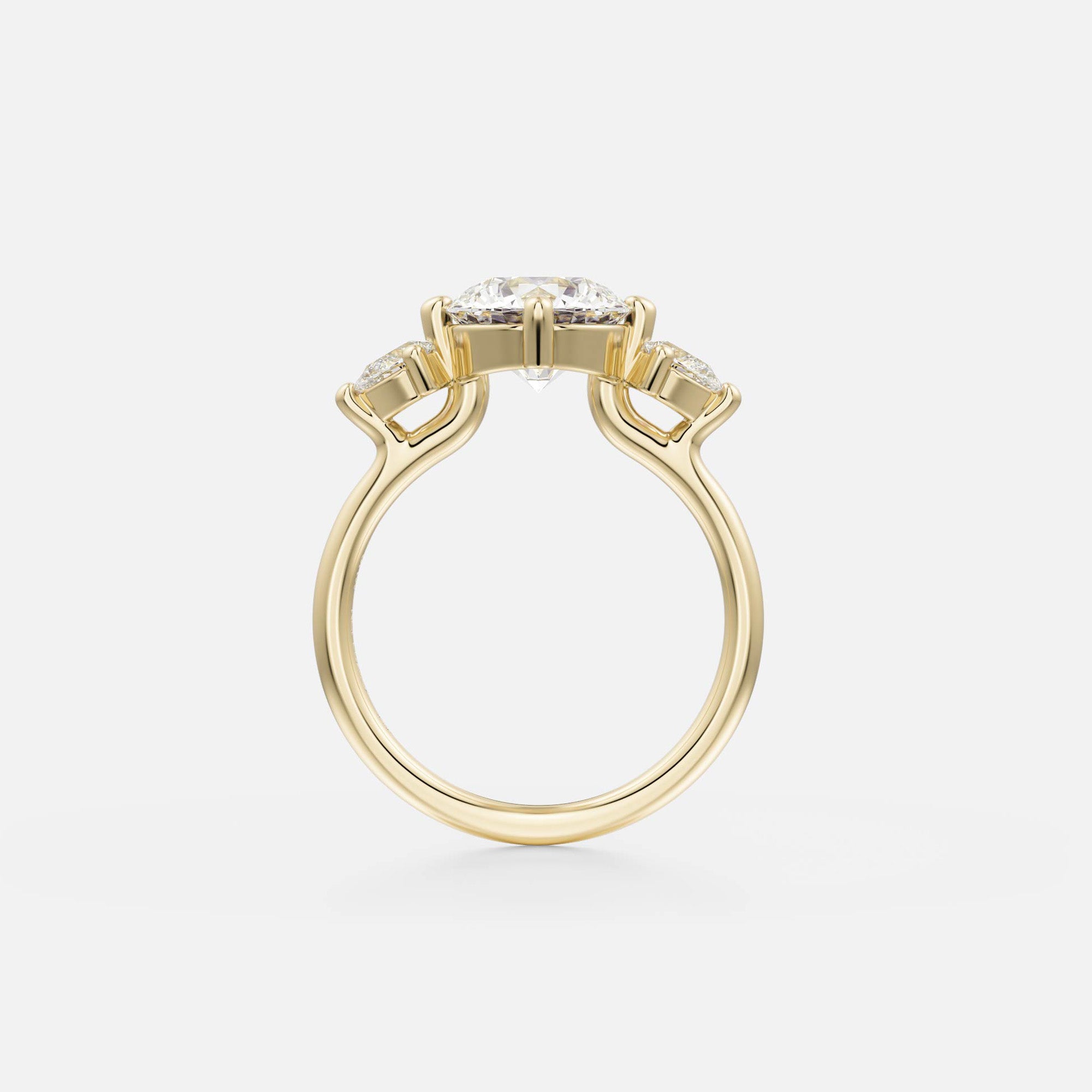 side view of round brilliant diamond three stone engagement ring with pear side stones on delicate round band open setting