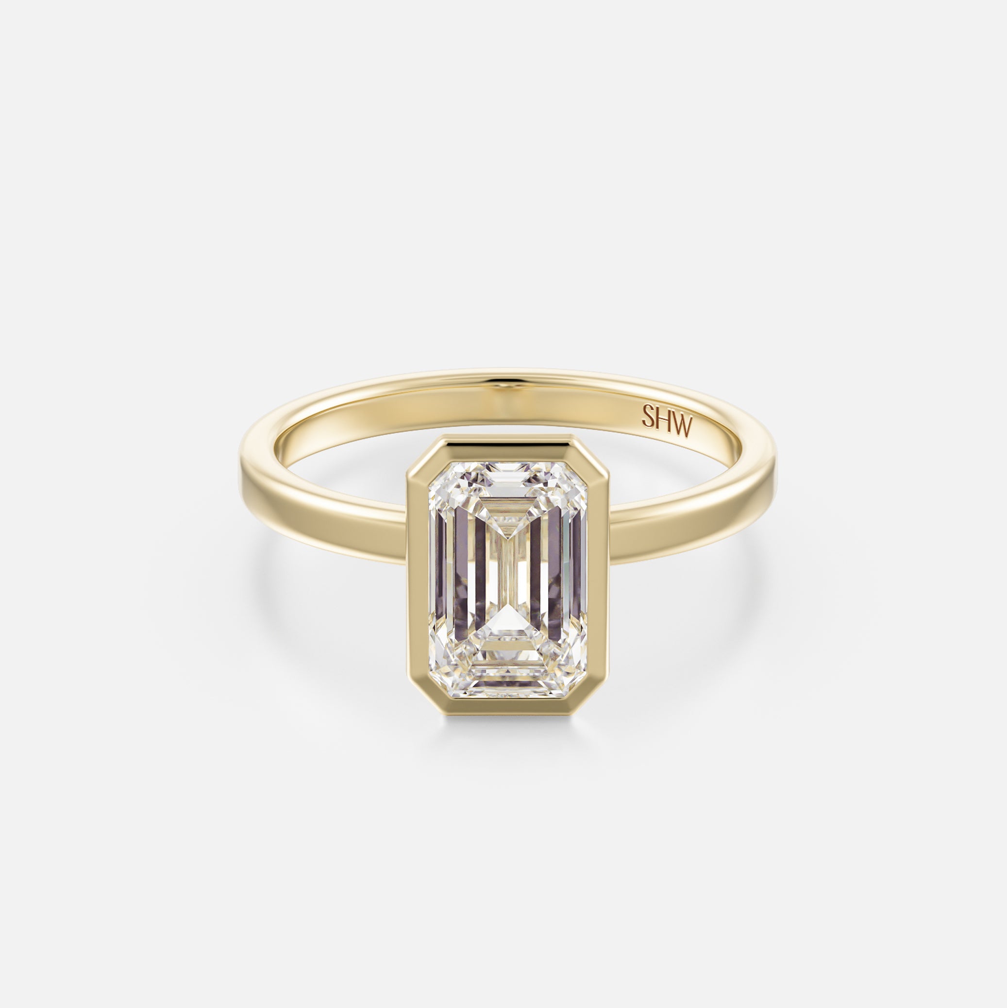 14k yellow gold thin flat band engagement ring with 2 carat emerald-cut diamond in bezel setting