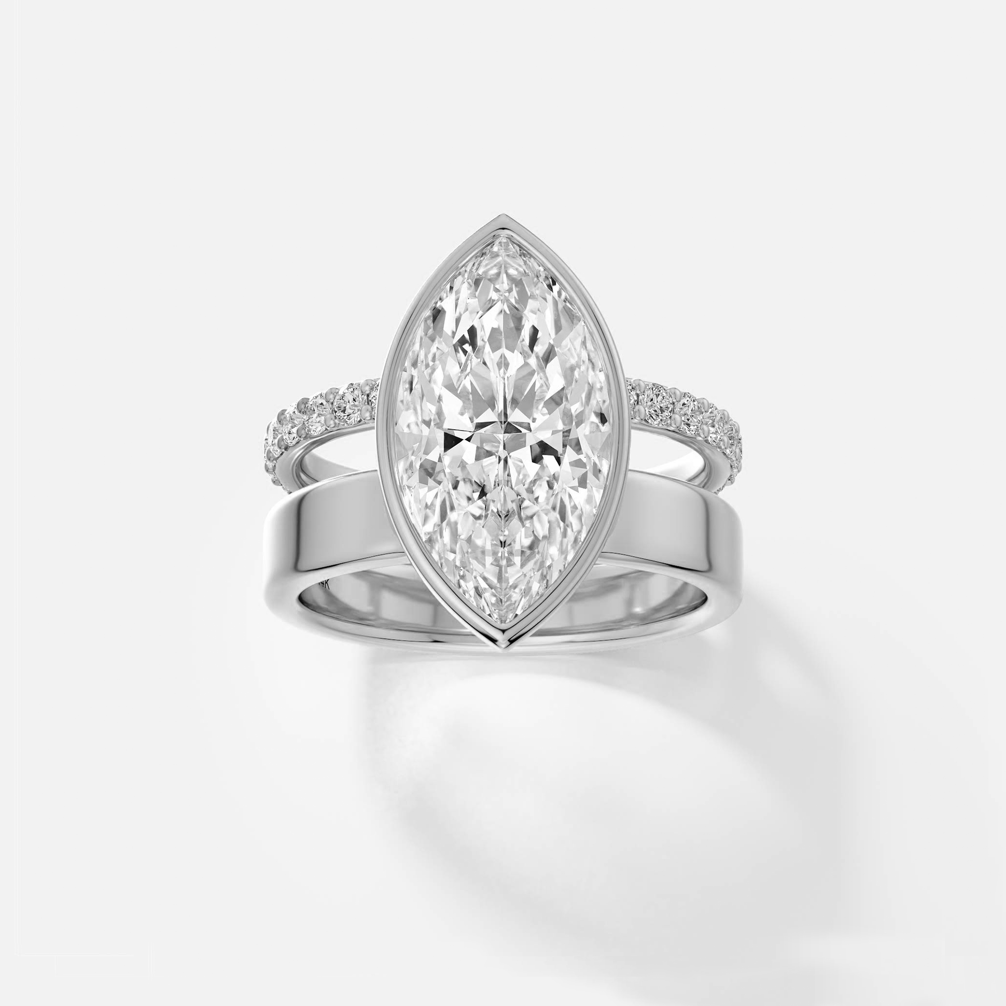 platinum engagement ring with 4.00 carat marquise diamond bezel setting and pavé diamond eternity band on double band