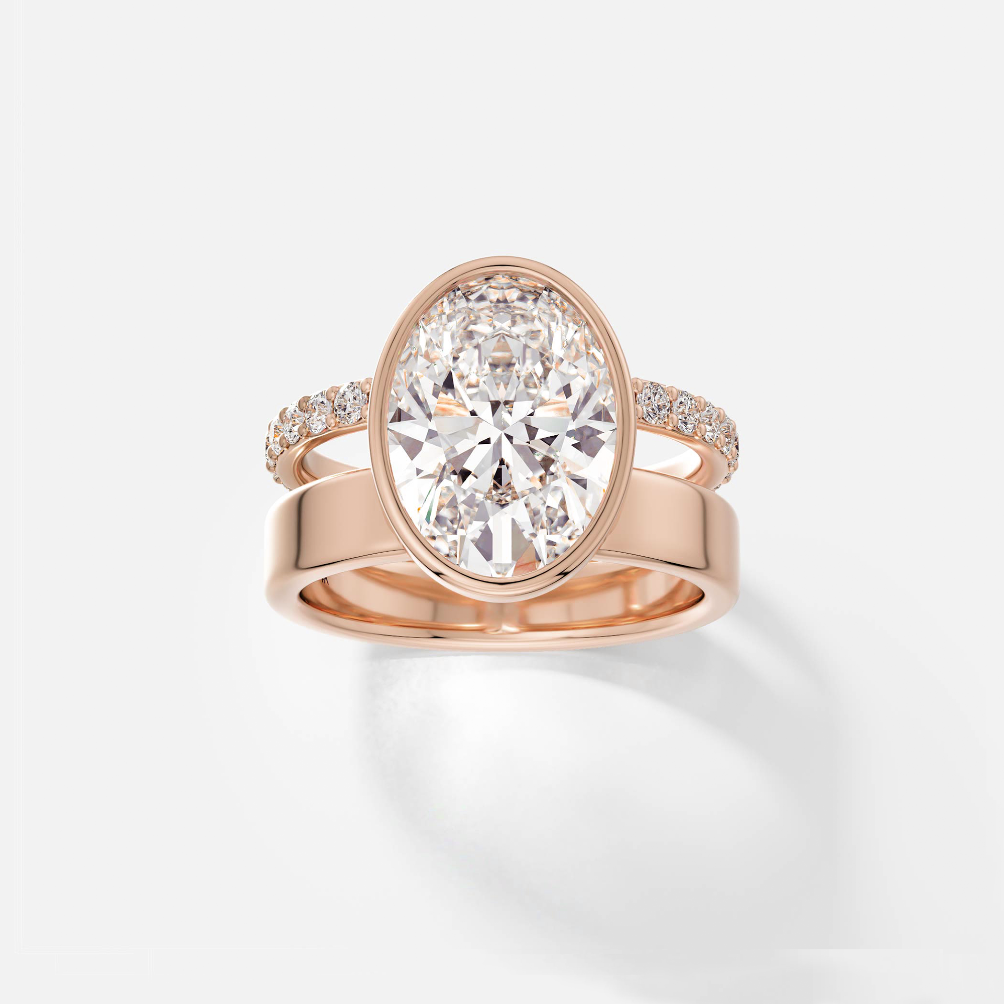 14k rose gold engagement ring with 4 carat oval diamond in bezel setting and pavé diamond eternity band