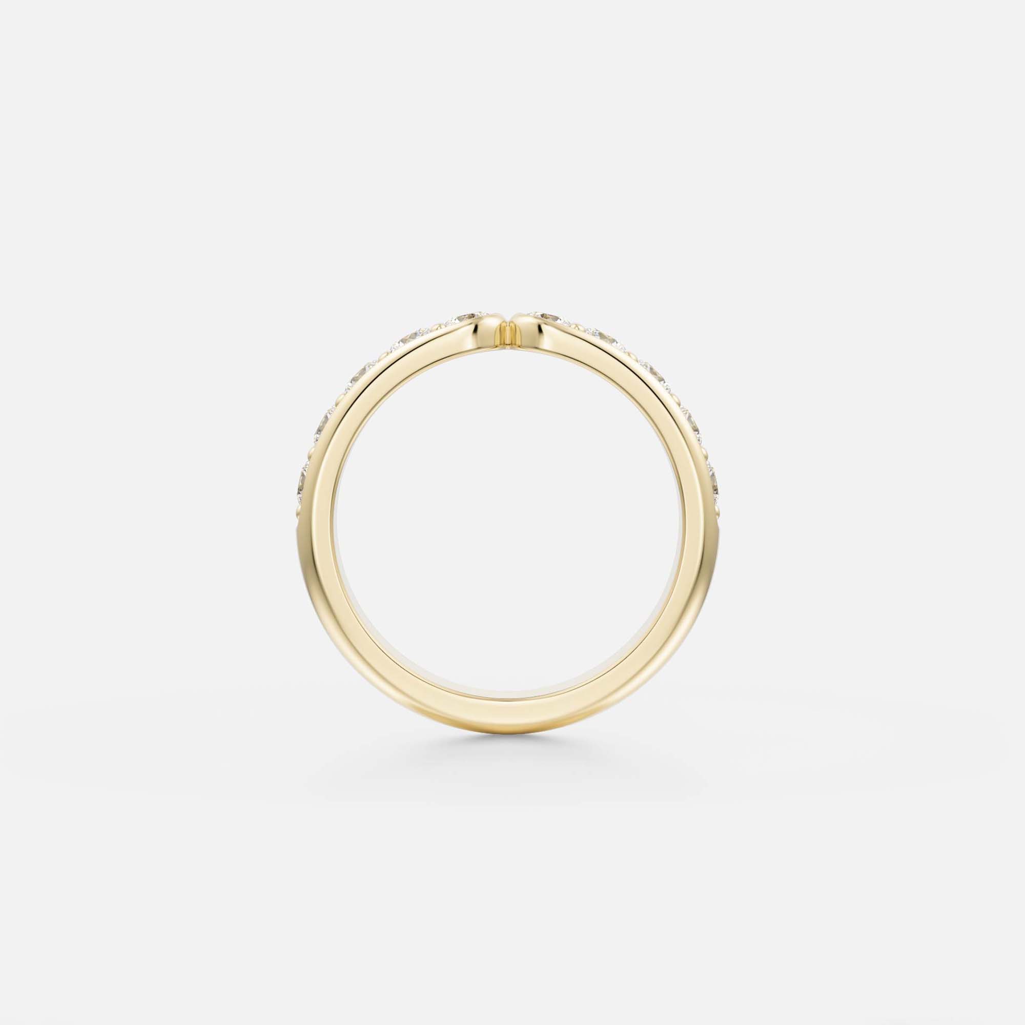 Sculptural side profile of a 14k yellow gold stackable wedding band with pavé round diamonds