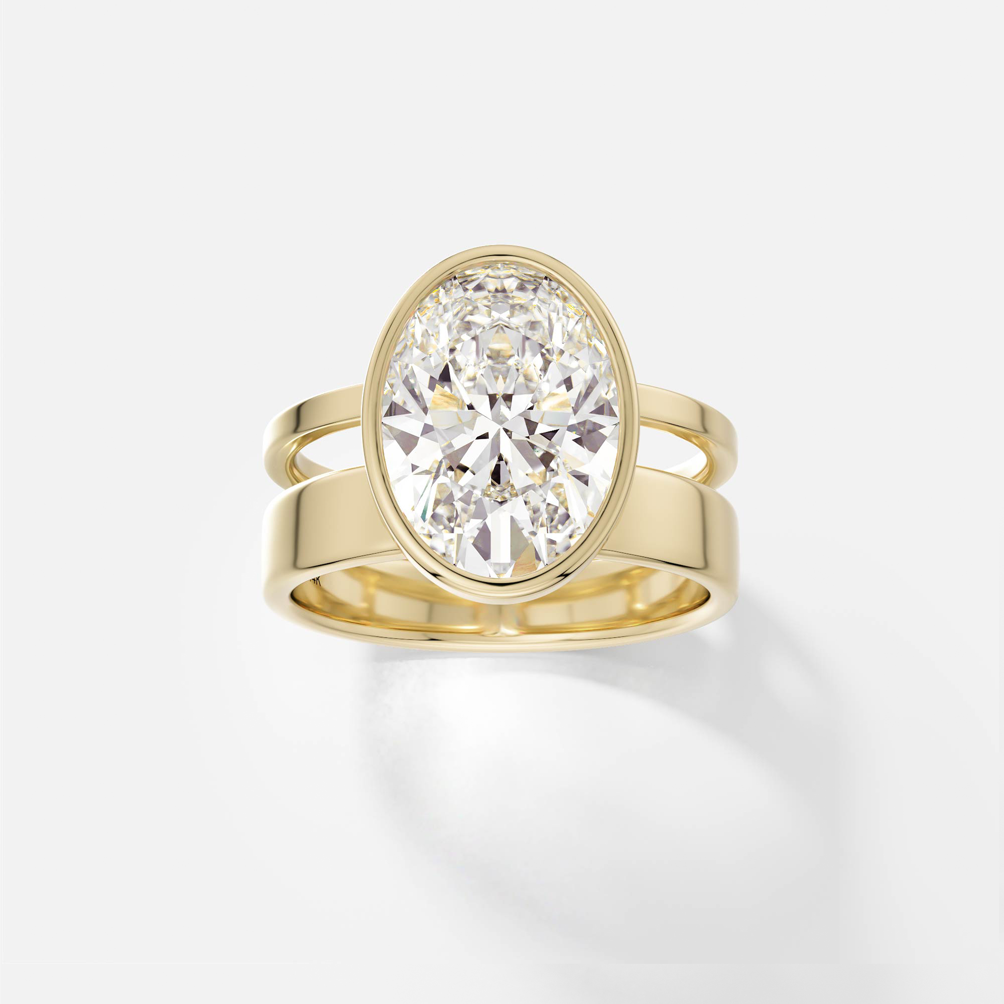 14k yellow gold engagement ring with 4.00 carat oval diamond bezel set on sculptural asymmetrical double band design