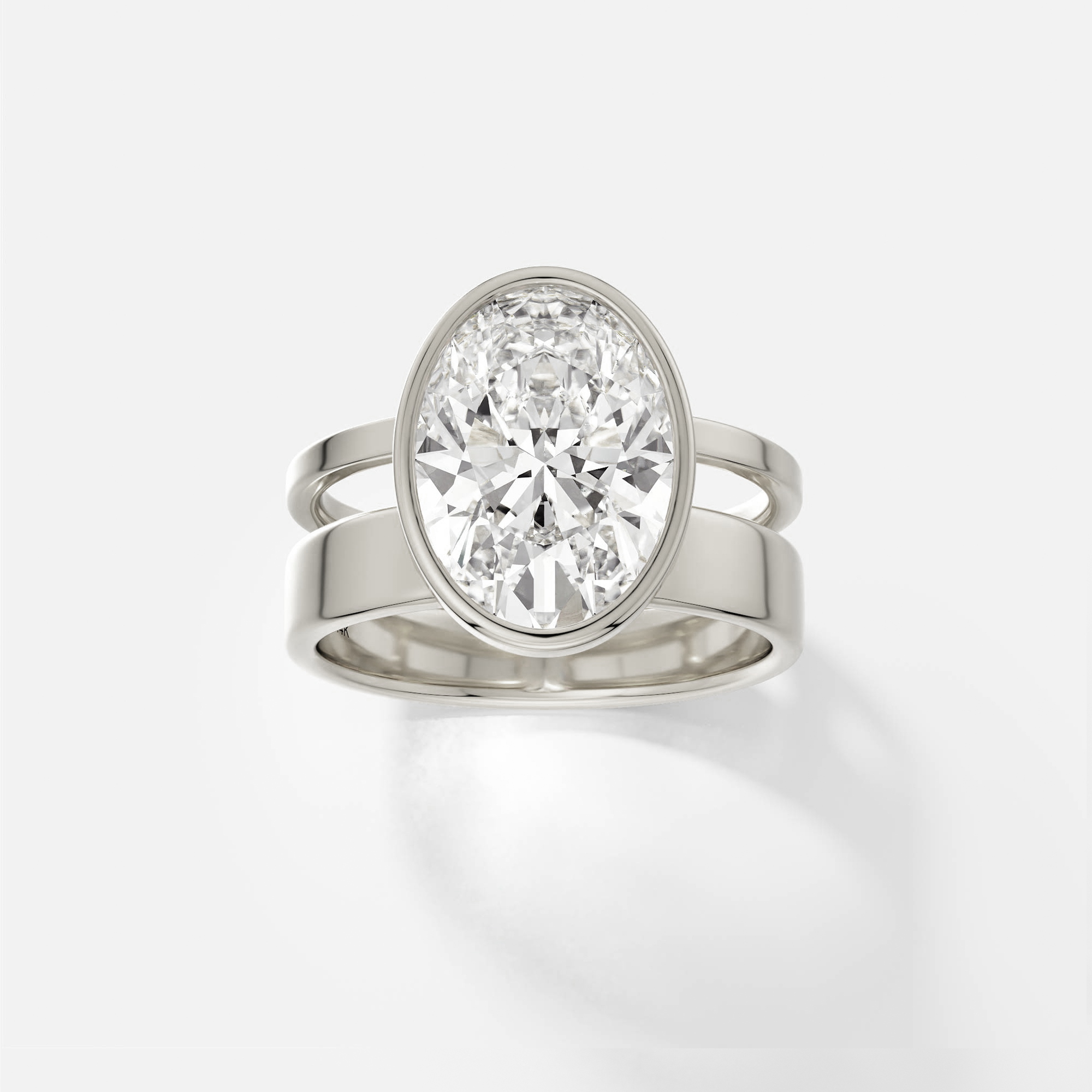 14k white gold engagement ring with 4.00 ct oval diamond in bezel setting on sculptural double band