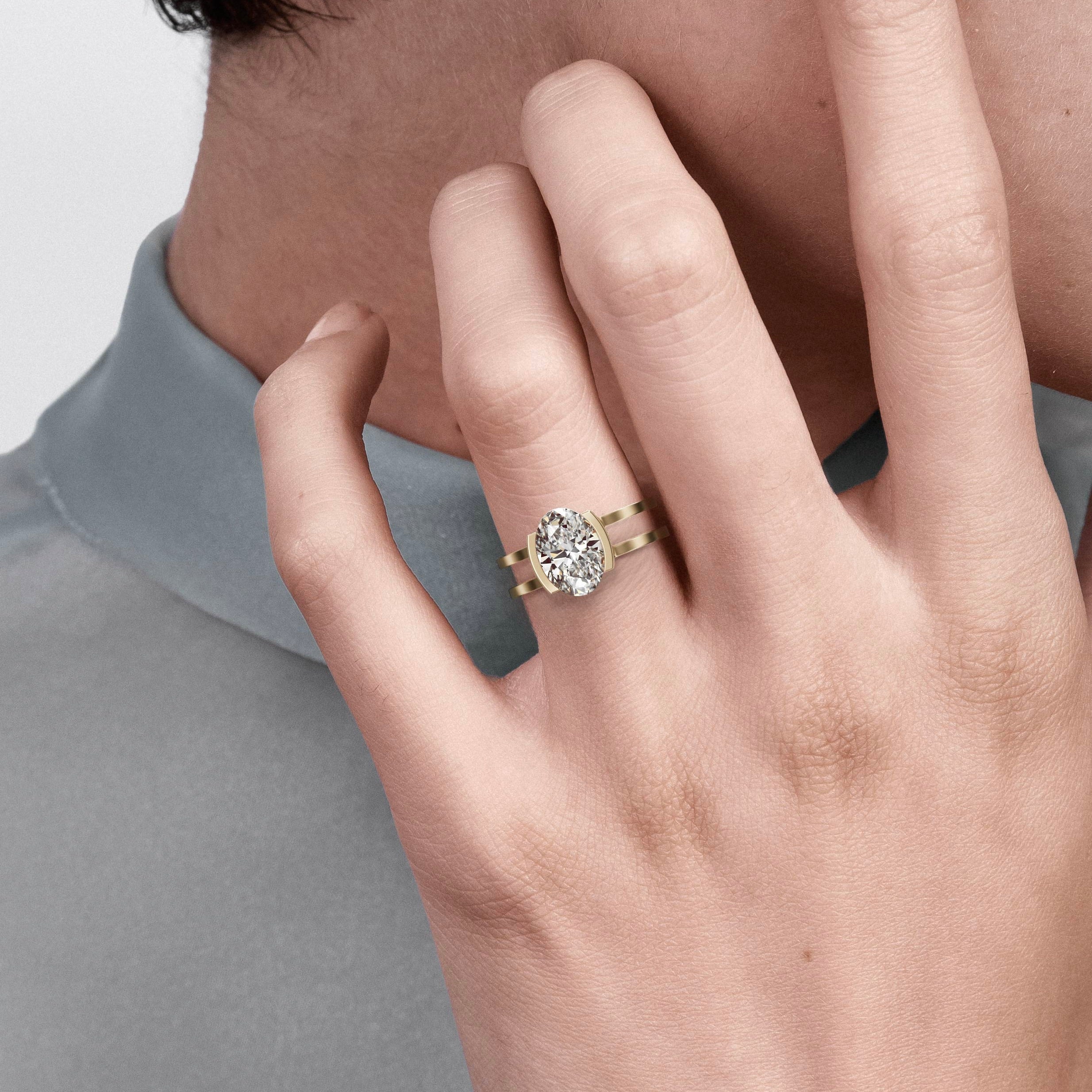 close view of elongated oval diamond engagement ring with double band and partial bezel