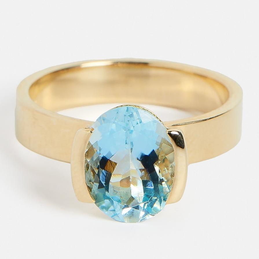 Minimalist Semi Bezel Set Engagement Ring with blue aquamarine gemstone in 14 karat yellow gold by SHW coolest fine jewelry store in NYC