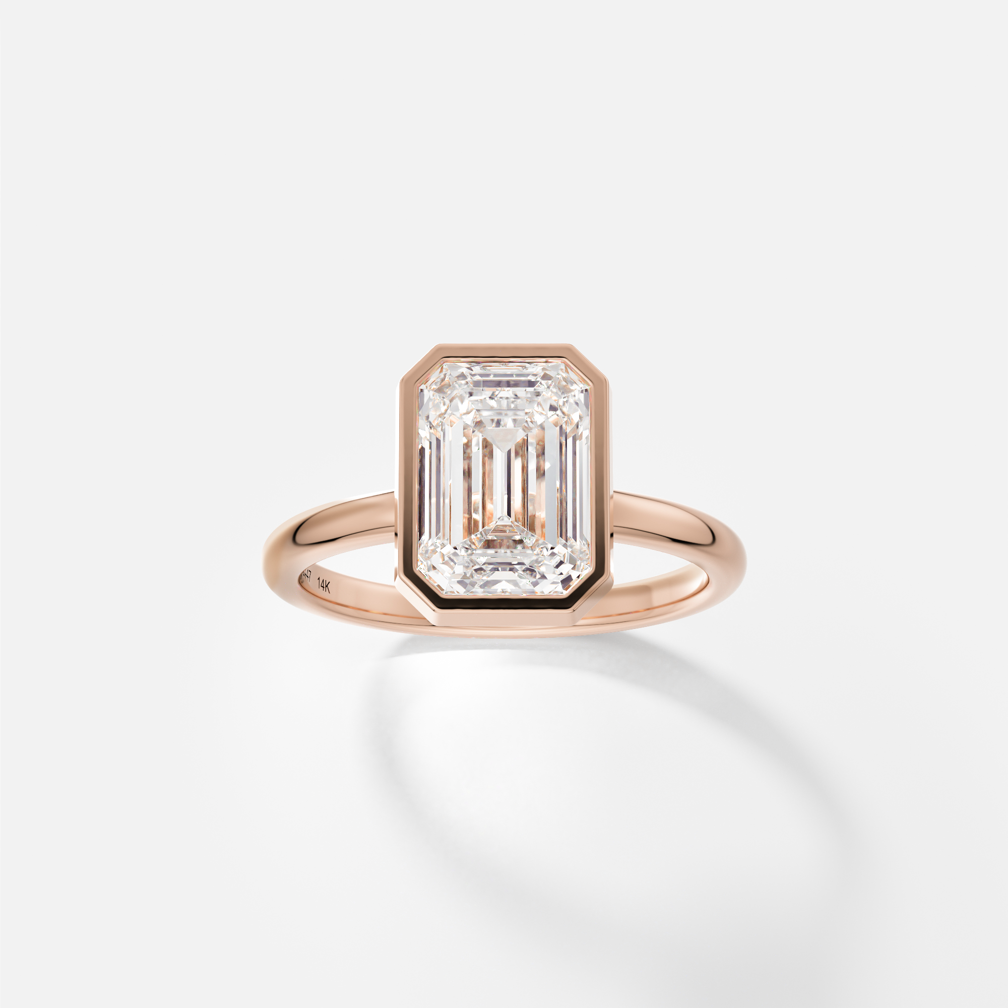 14k rose gold engagement ring with 2.50 carat emerald-cut diamond bezel set on 2mm domed band