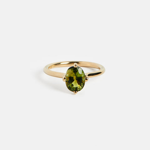Hooks setting engagement ring with oval 1.5ct grassy green tourmaline gemstone in 14k yellow gold by SHW famous fine jewelry store in NYC