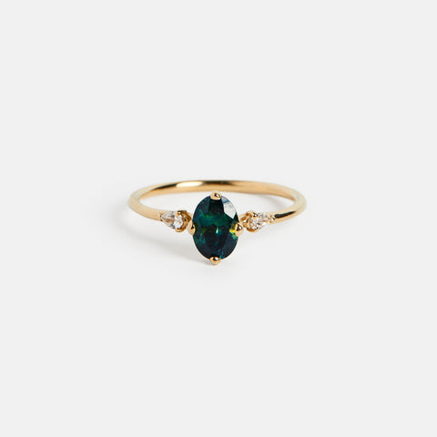 Three stone unique engagement ring setting with oval 1ct teal blue sapphire and white diamonds on side in 14k yellow gold SHW Jewelry NYC