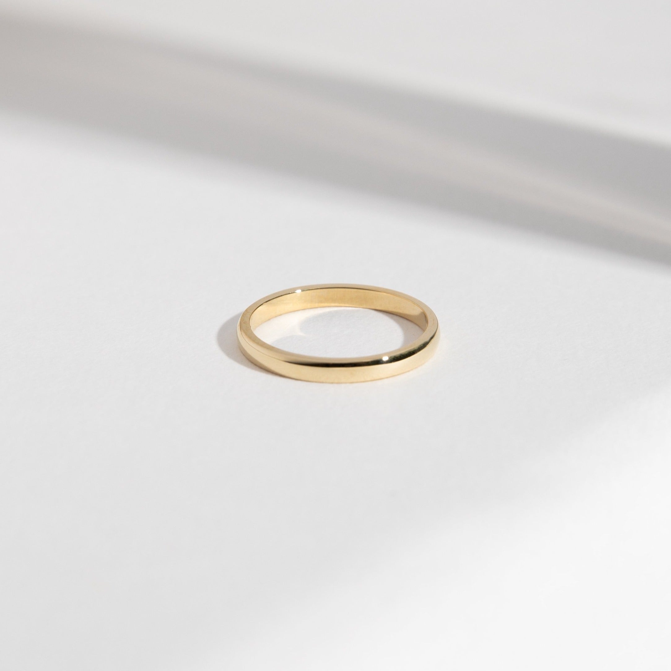 14k yellow gold 2mm domed wedding band with smooth rounded profile