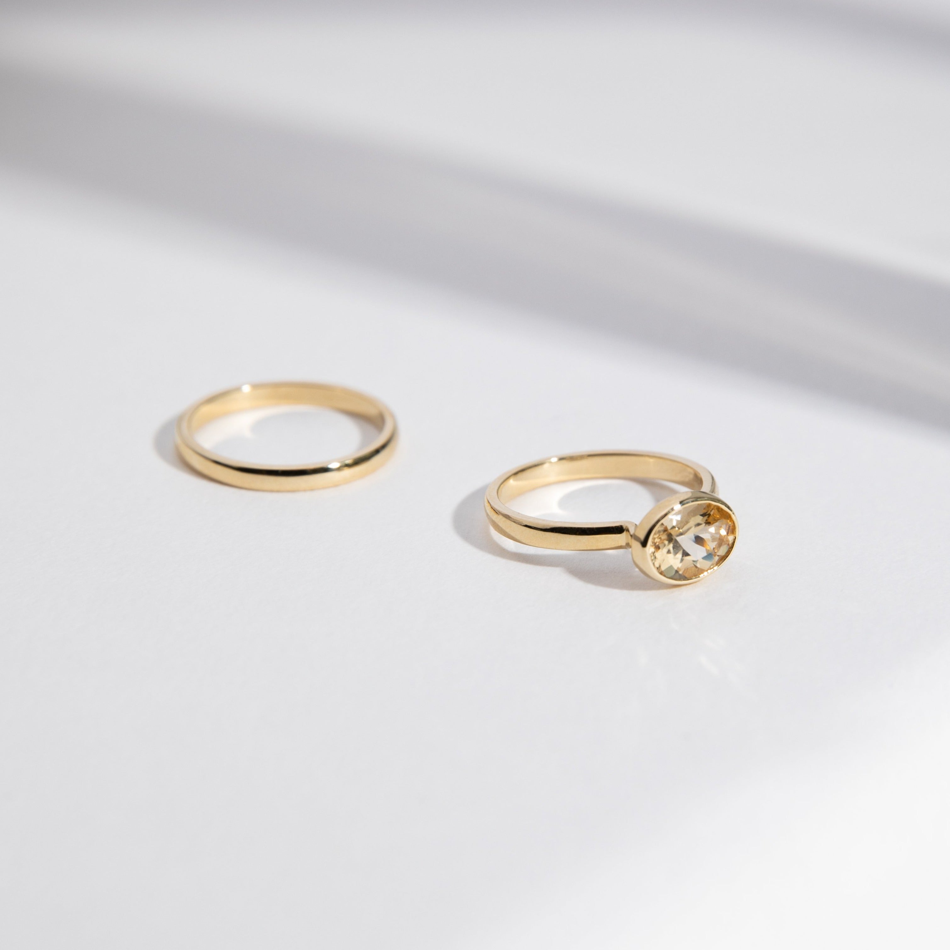 2mm domed gold wedding band shown next to another band