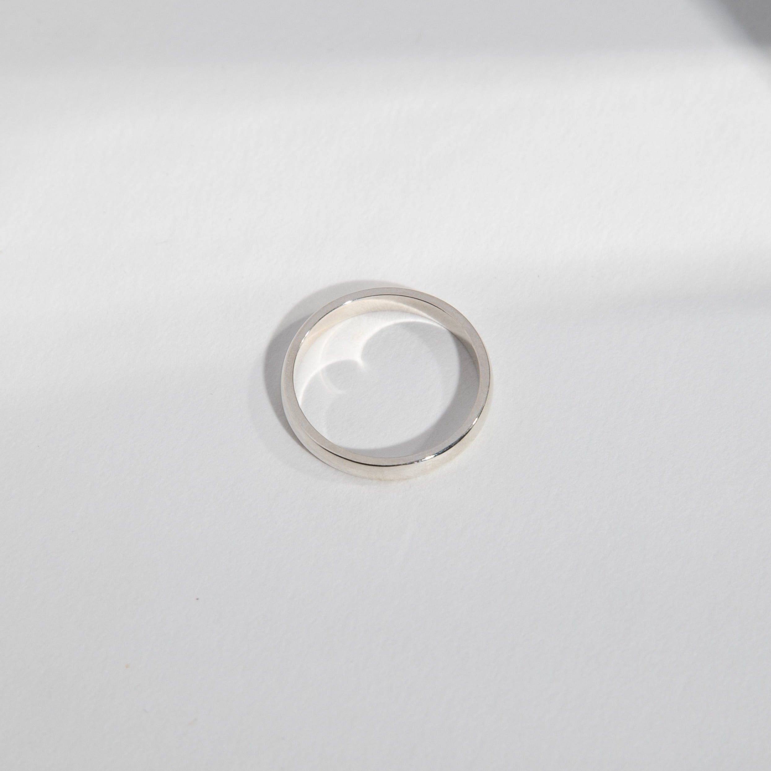 Side view of a 3mm white gold wedding band with classic domed shape
