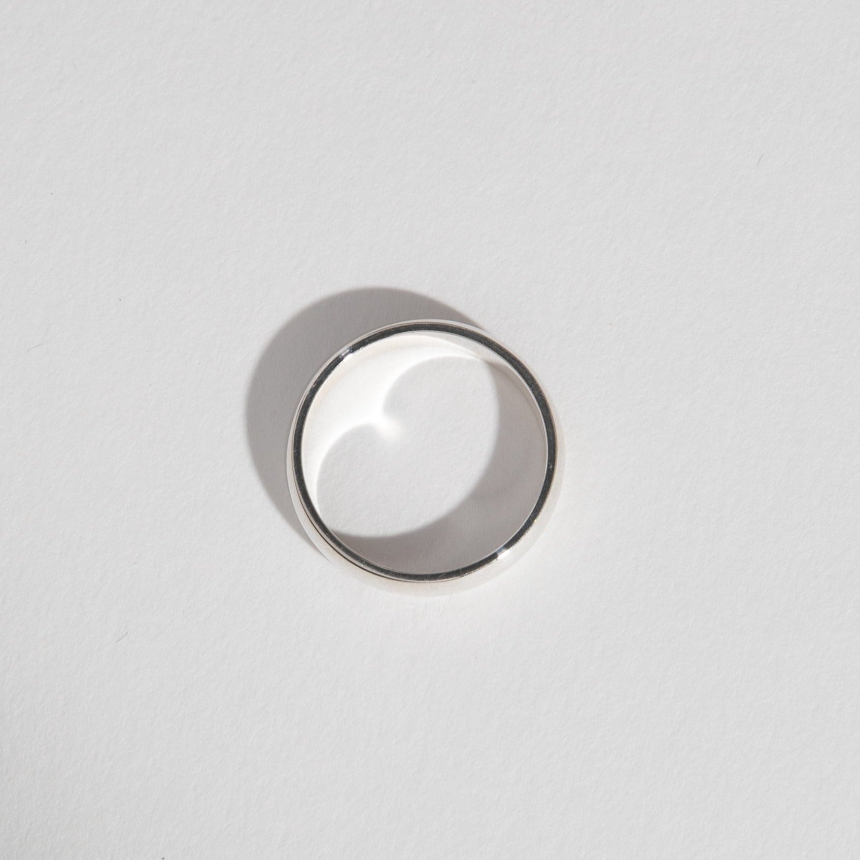 Side view of a 5mm white gold wedding band with classic domed shape