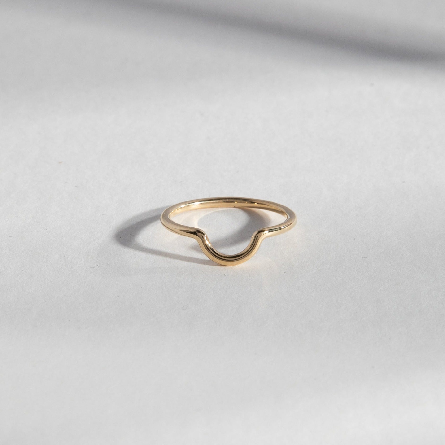 14k yellow gold thin round band with curved front detail