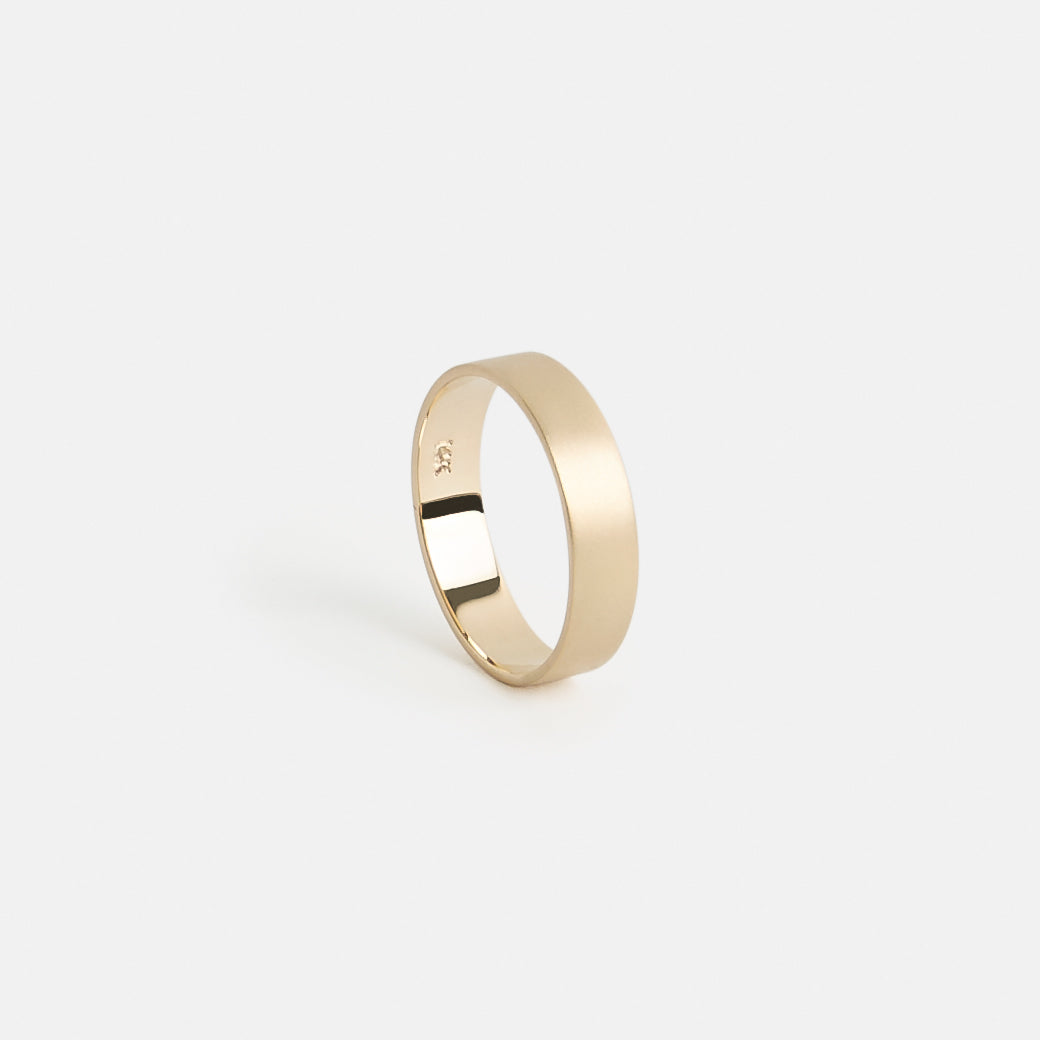 Flat profile gold wedding band with textured matte surface