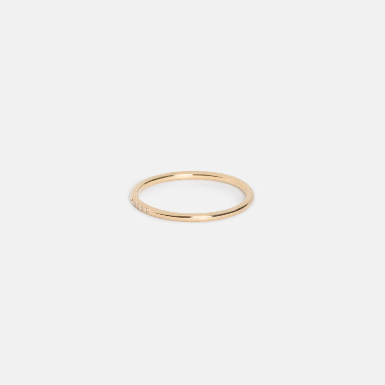 Delicate gold band with five small round diamonds set along the top