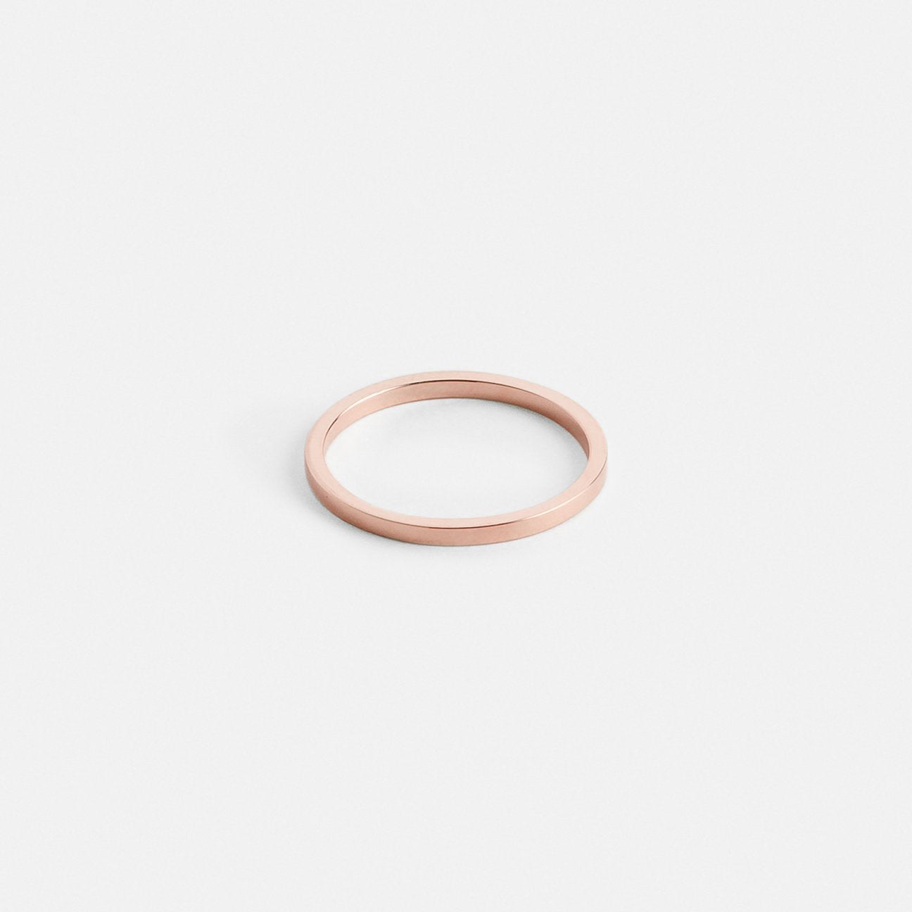 14k rose gold thin flat wedding band with minimal silhouette