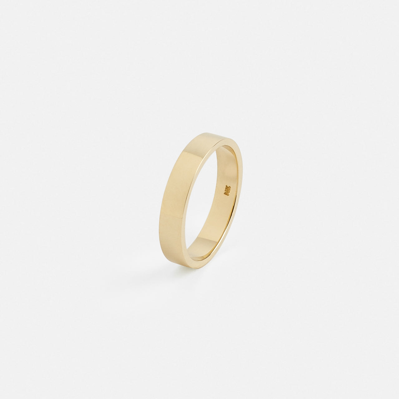 Solid gold flat wedding band showing clean straight edges
