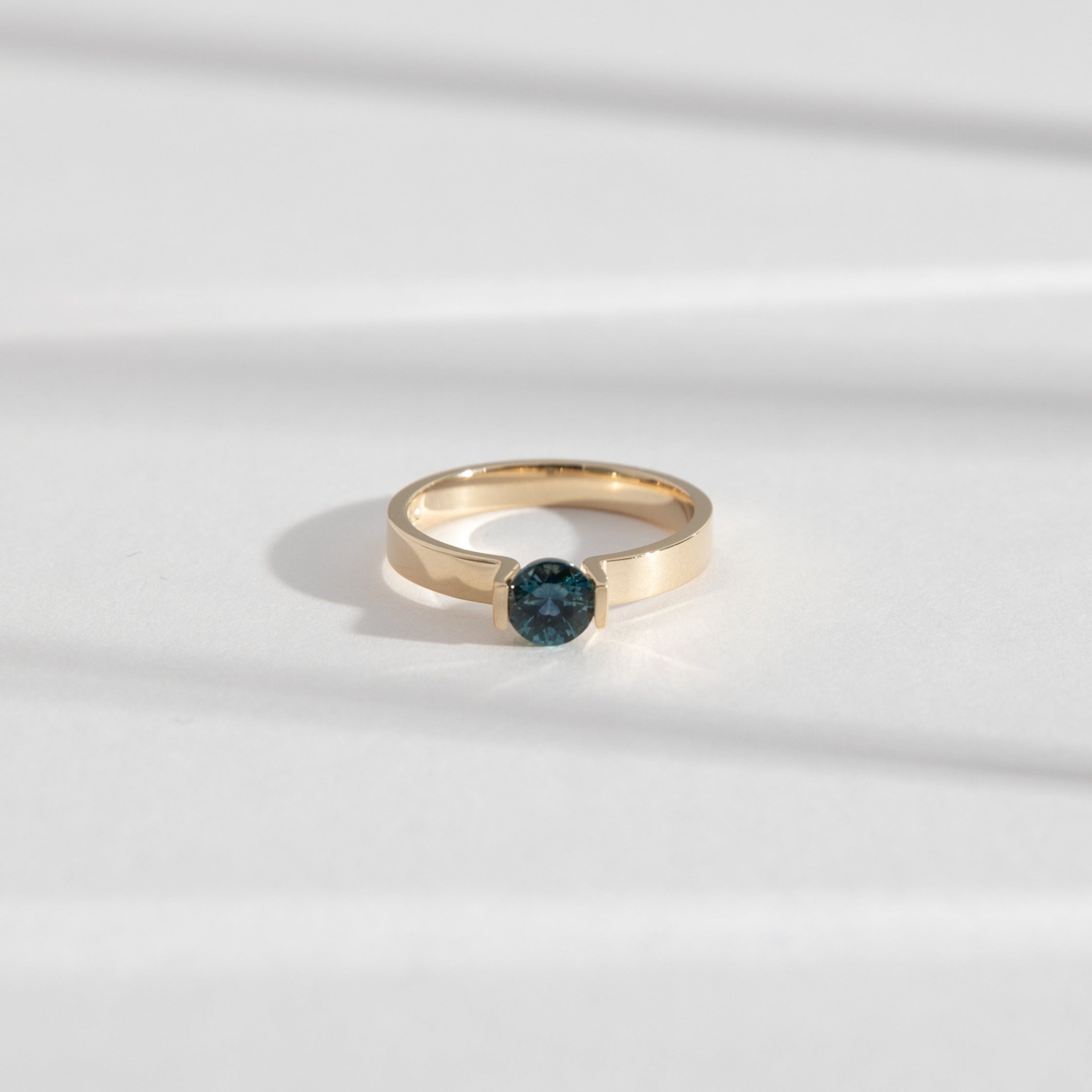 Lara Alternative Ring in 14k Gold set with a 0.59ct round brilliant cut dark teal sapphire By SHW Fine Jewelry NYC