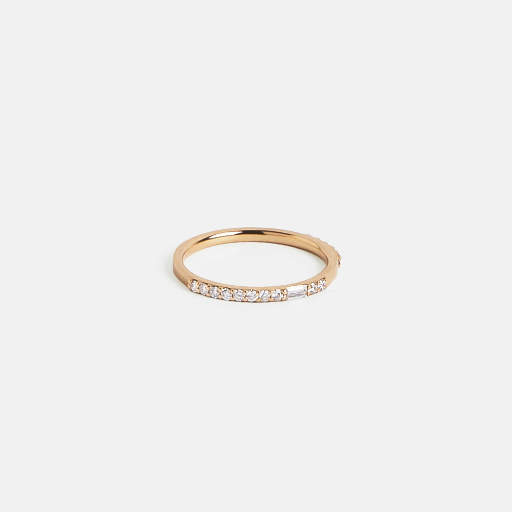 Gold eternity band with negative space between round and baguette diamonds