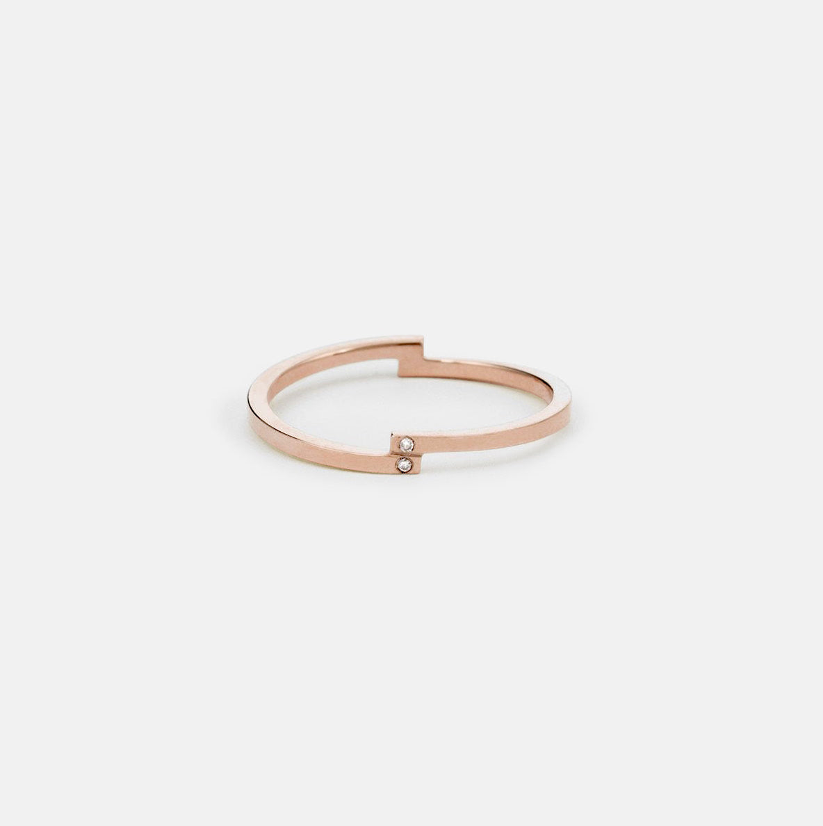 14k rose gold thin wedding band with four vertically set white diamonds