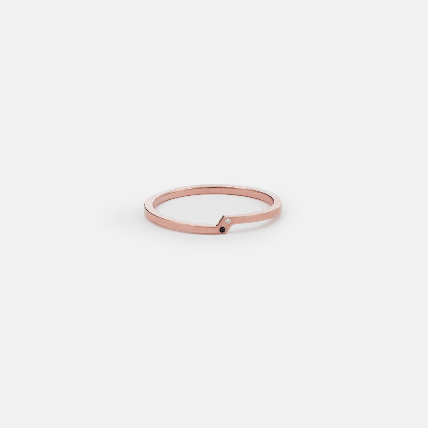14k rose gold sculptural ring with one white and one black diamond
