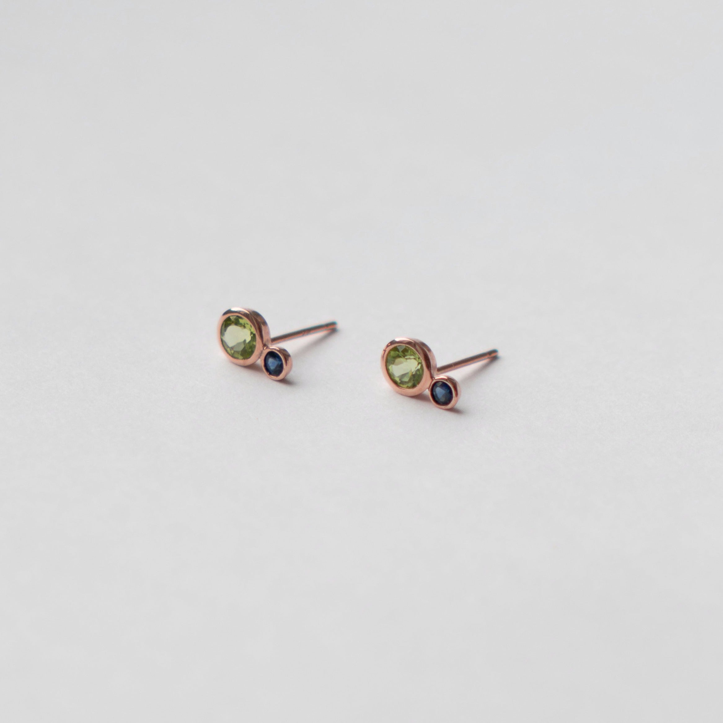 Kiki alternative stud earrings in 14k rose gold set with peridot and sapphire